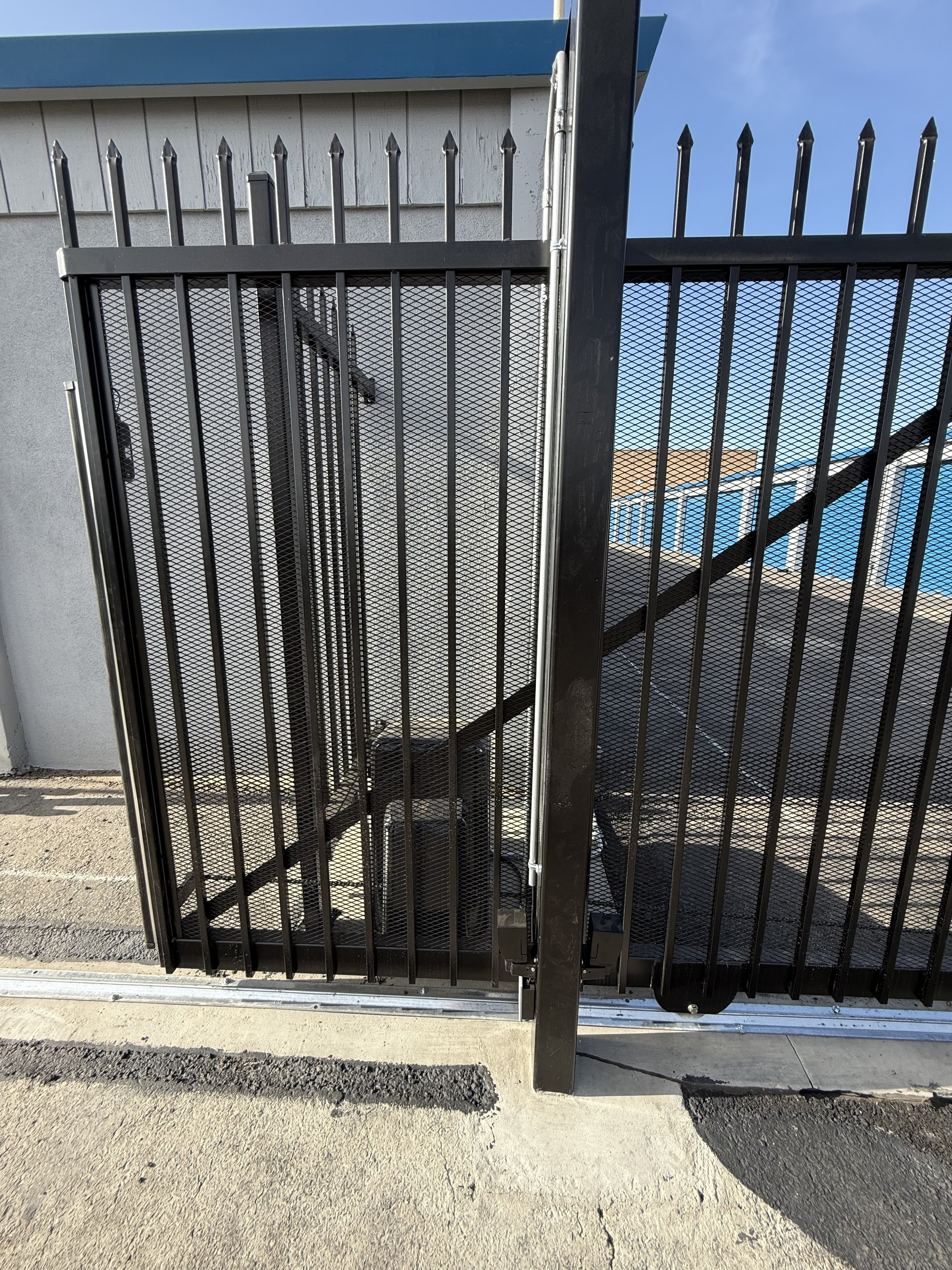 Modern automated slide gate with keypad entry for secure commercial property access