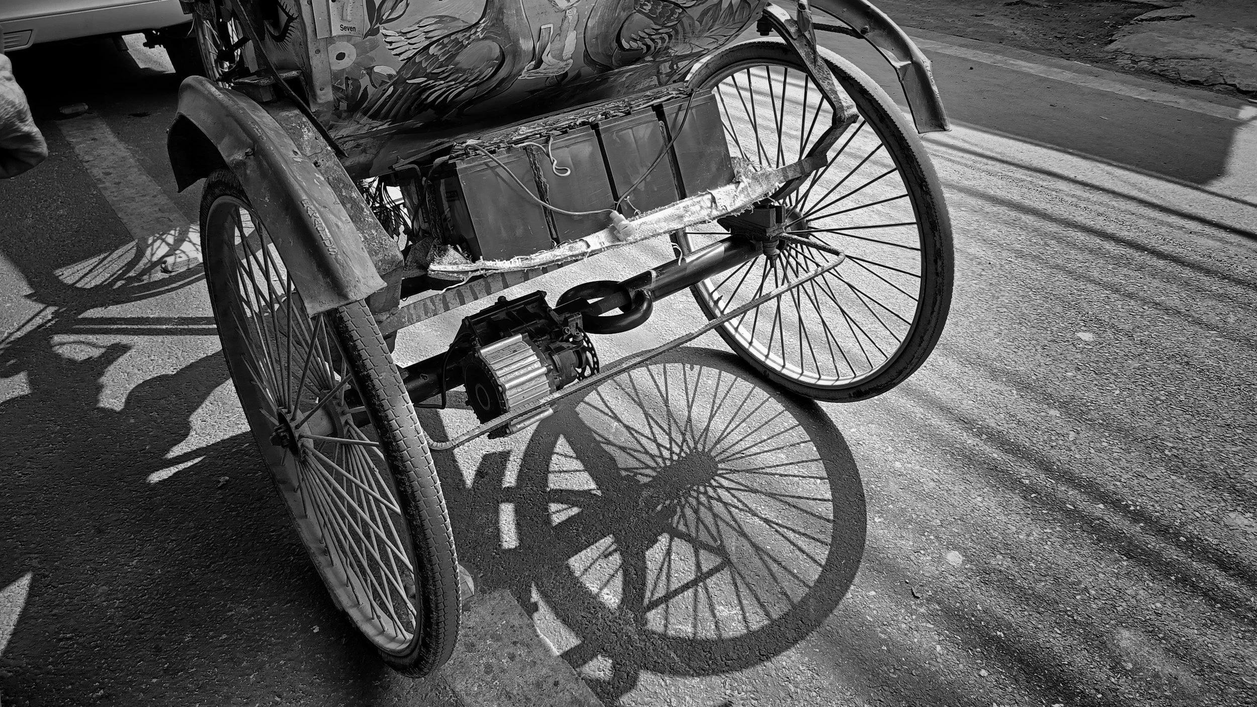 black and white photo of back of wheelchair with a motor