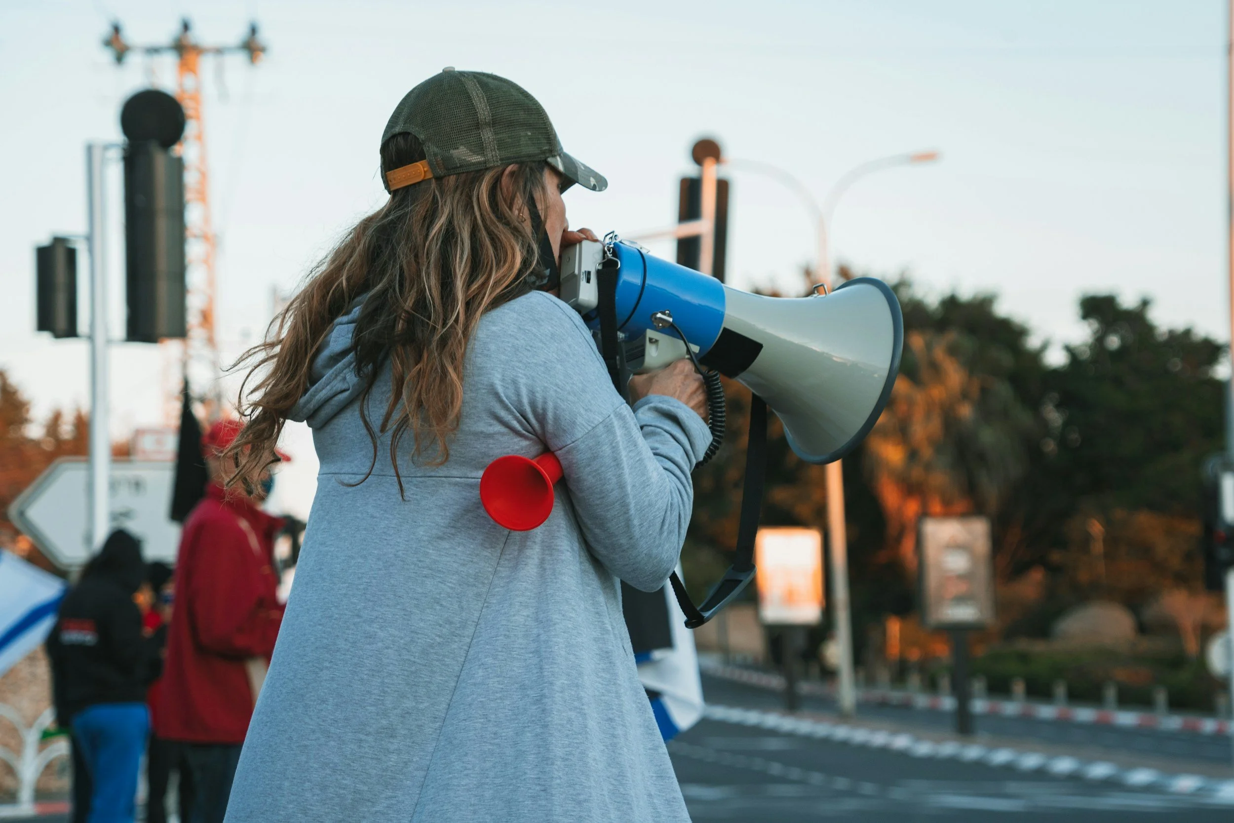 woman with loudspeaker shouting out at protest
