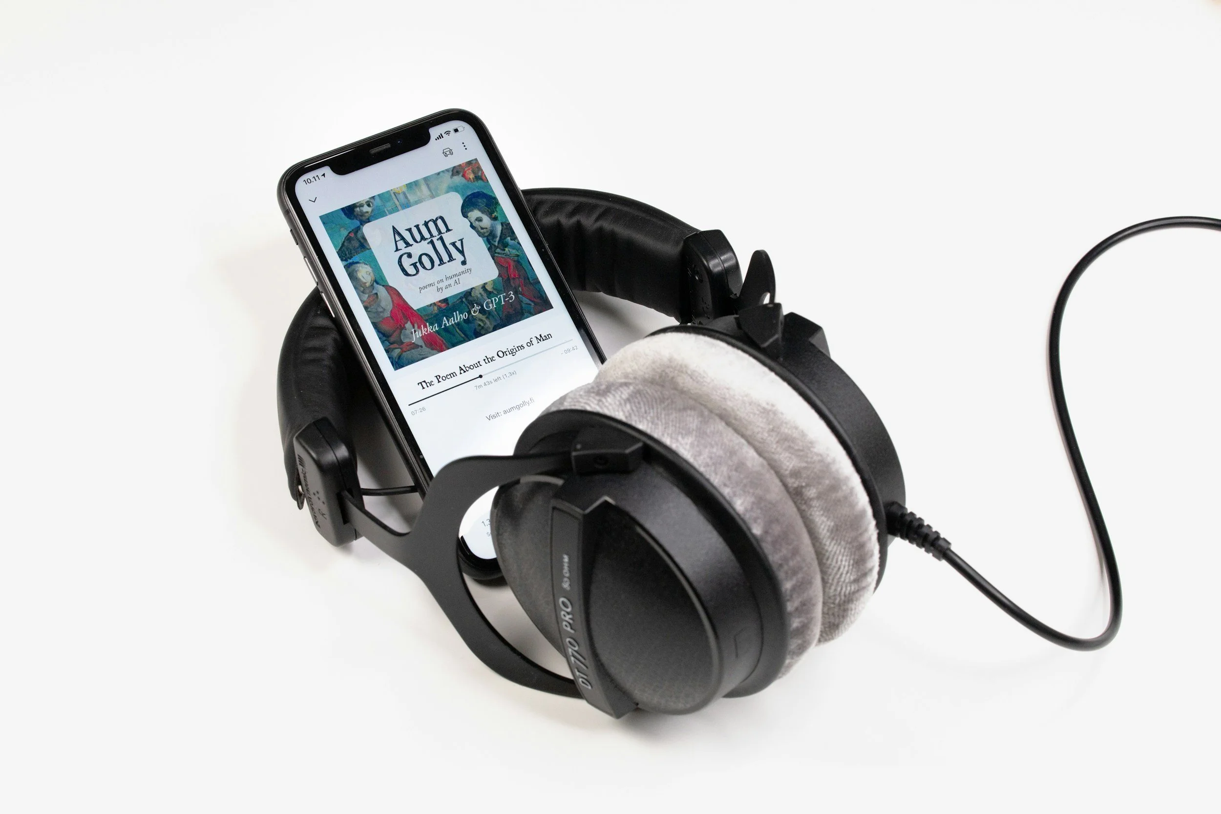 headphones with phone in the middle with audiobook playing