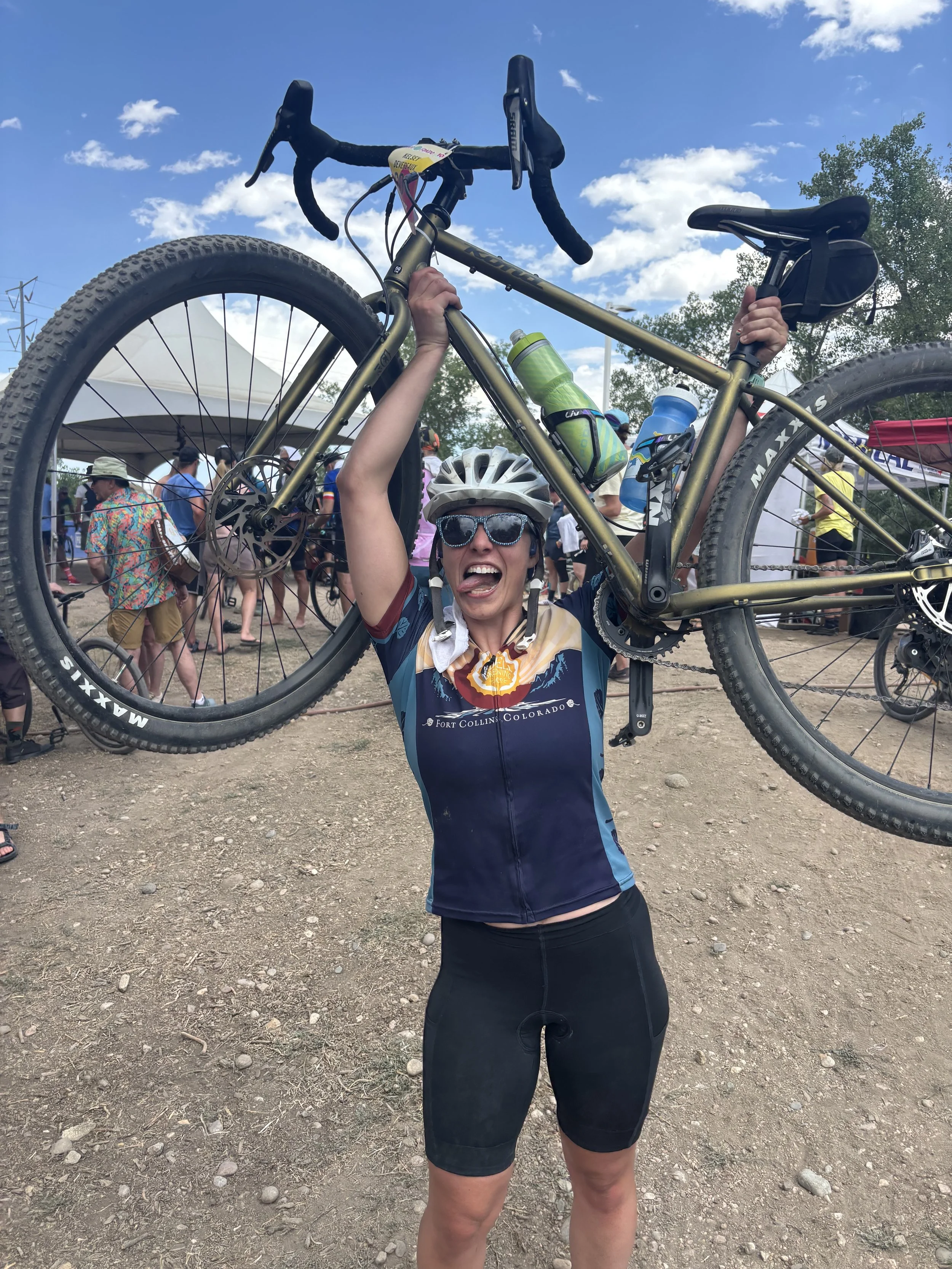 me lifting my bike above my head at the end of FoCo Fondo