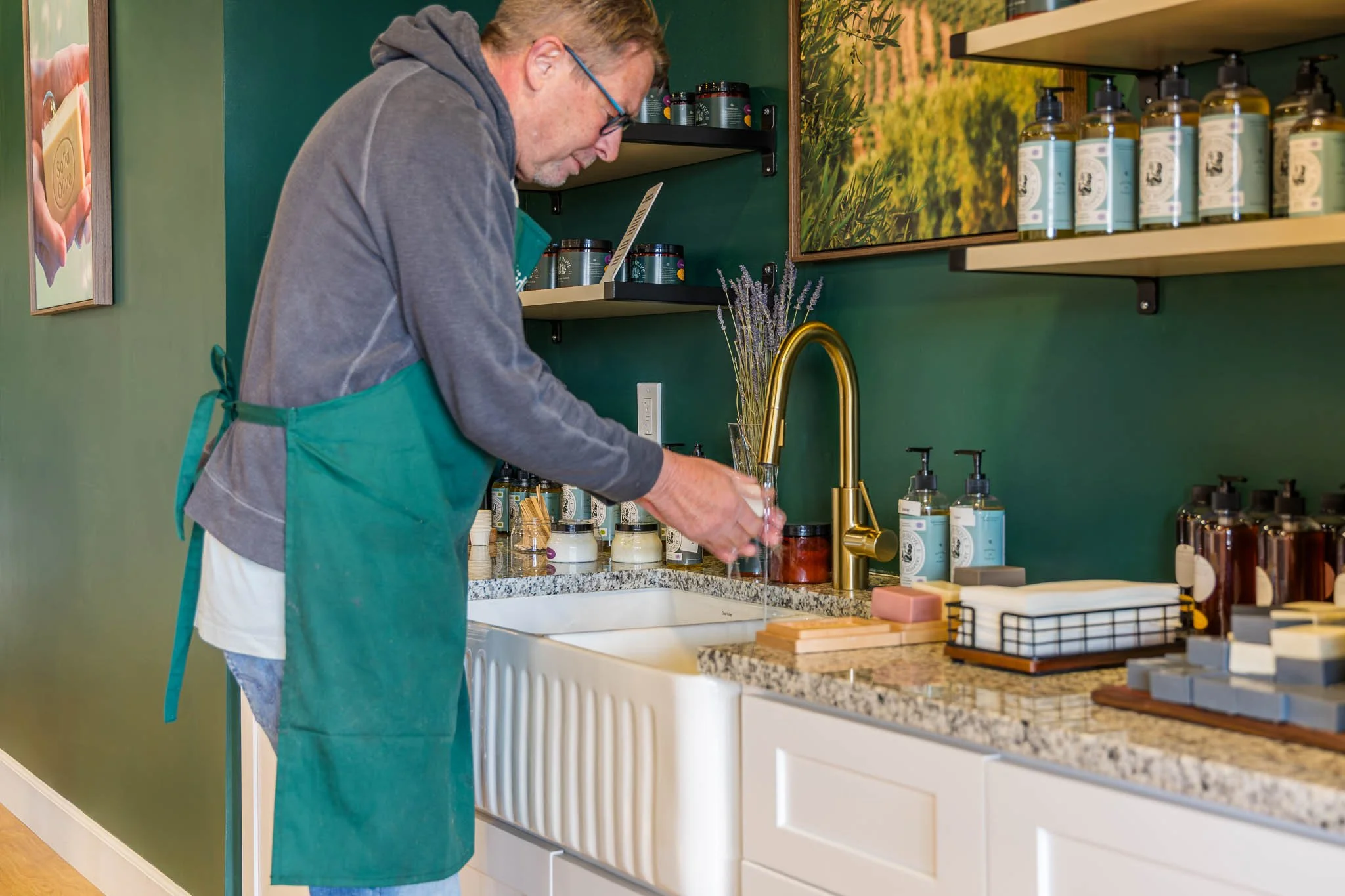 person washing hand with solid olive soap