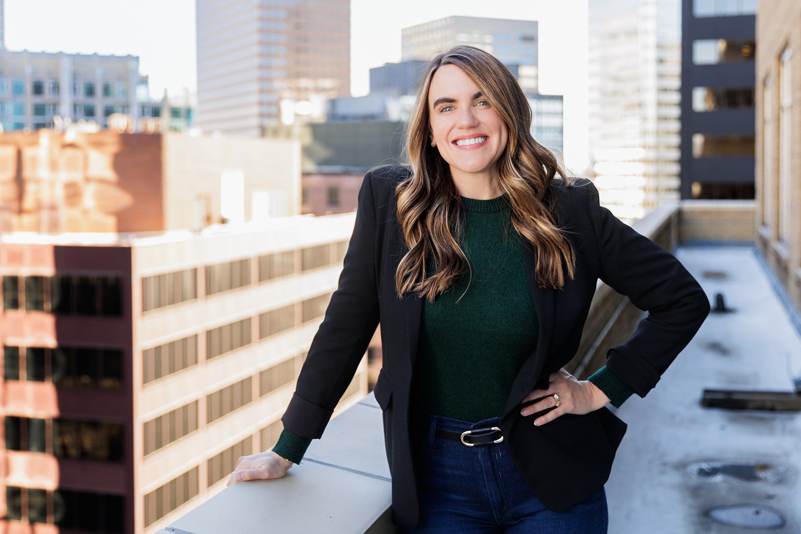 Woman on rooftop with city skyline