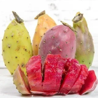 A group of prickly pears, with some cut open to reveal bright red fruit.