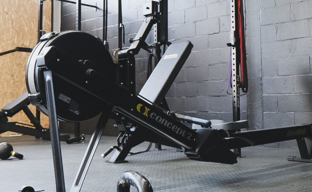 Indoor gym with rowing machine and weightlifting equipment