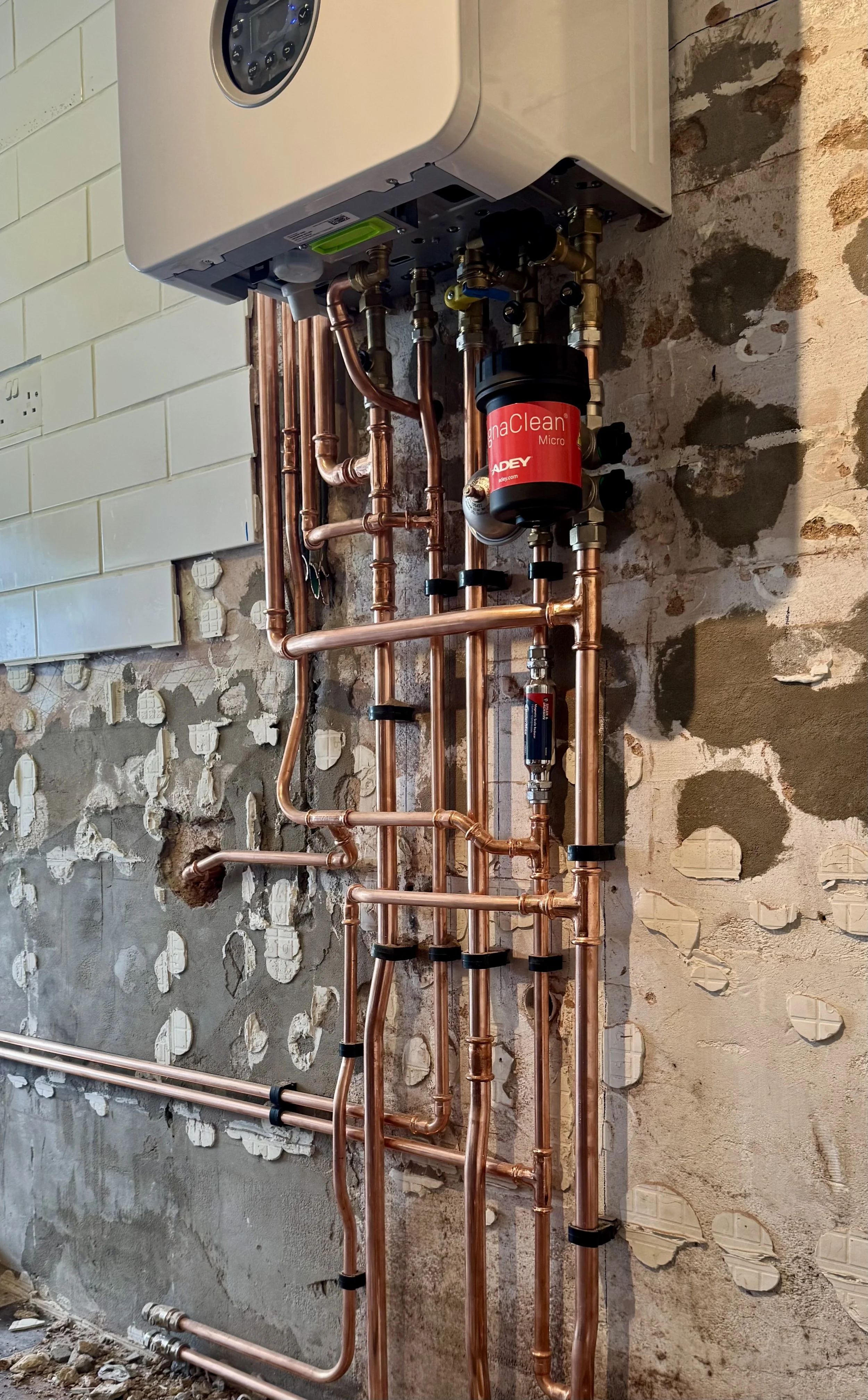 Copper piping and a water heater in a partially remodeled wall.