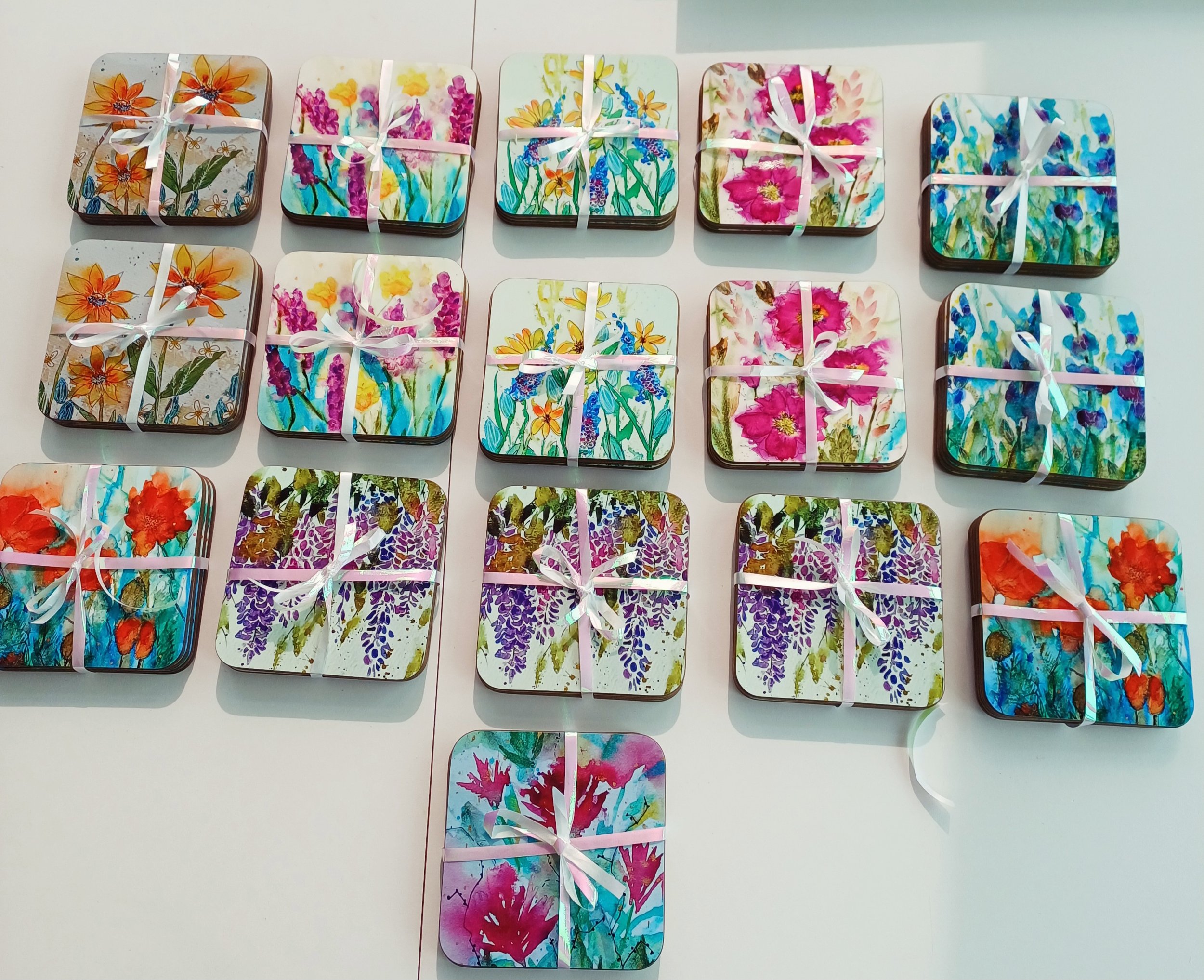 sets of 4 coasters (10cm x 10cm) hardback with gloss coating £14.50 per set: Rudbeckia, wild orchid, sunshine daisy, magenta cosmos, snapdragons, poppies, wisteria and magenta bloom.
