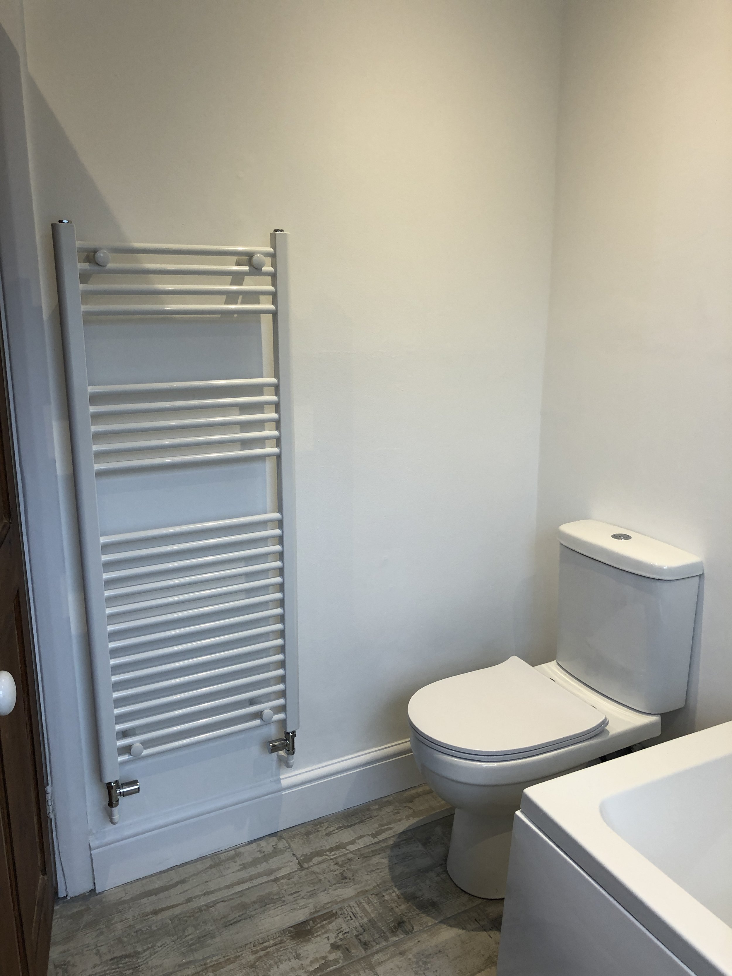 Bathroom with white heated towel rail and toilet, South London