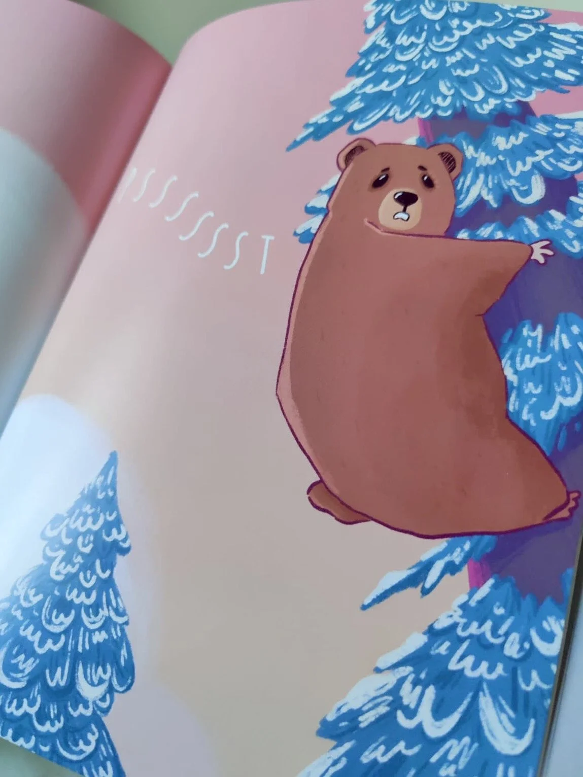 Photography of a page within 'The Confidence Trick' depicting a bear stuck in a tree