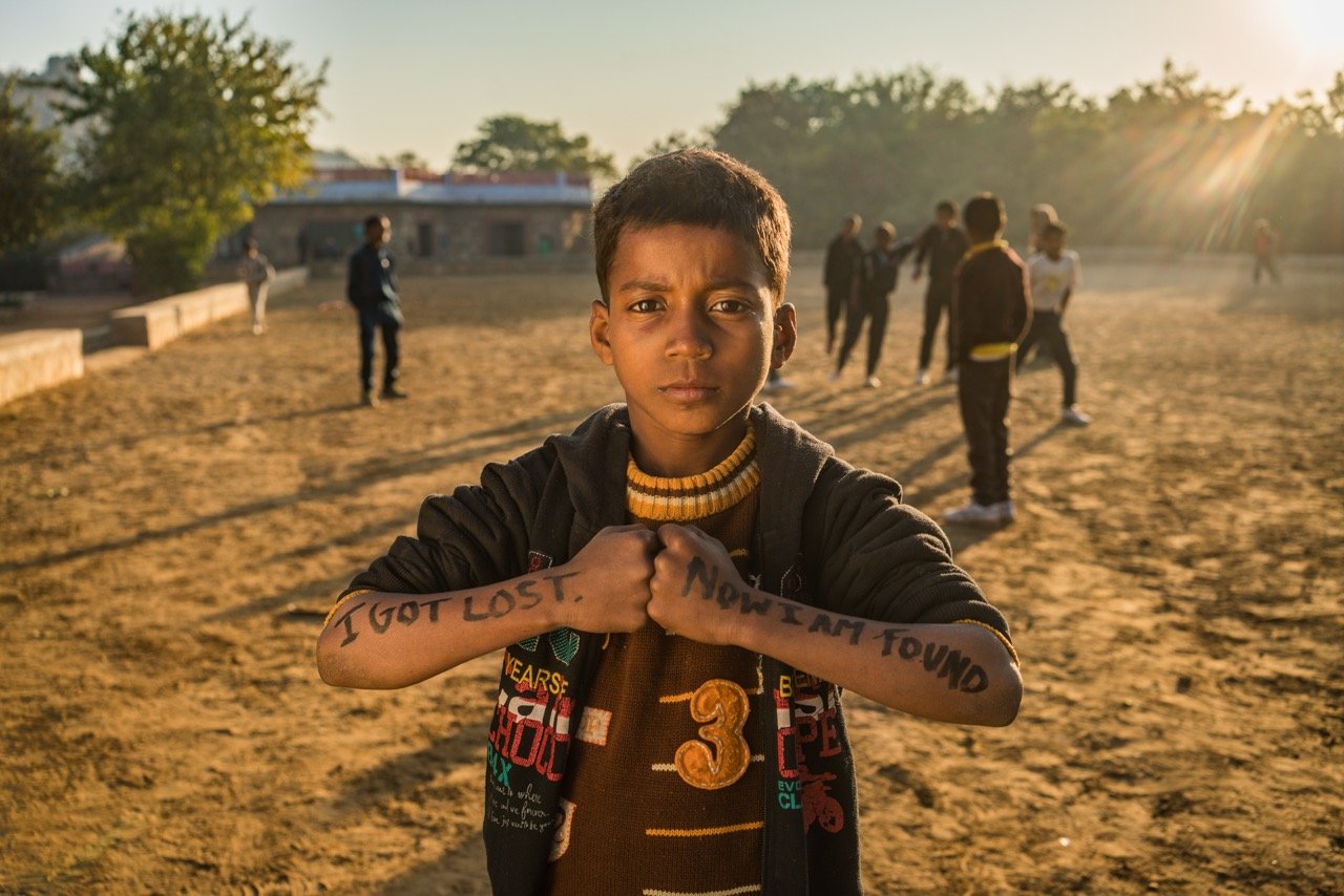 Boy with arms that say I got lost, now i am found.