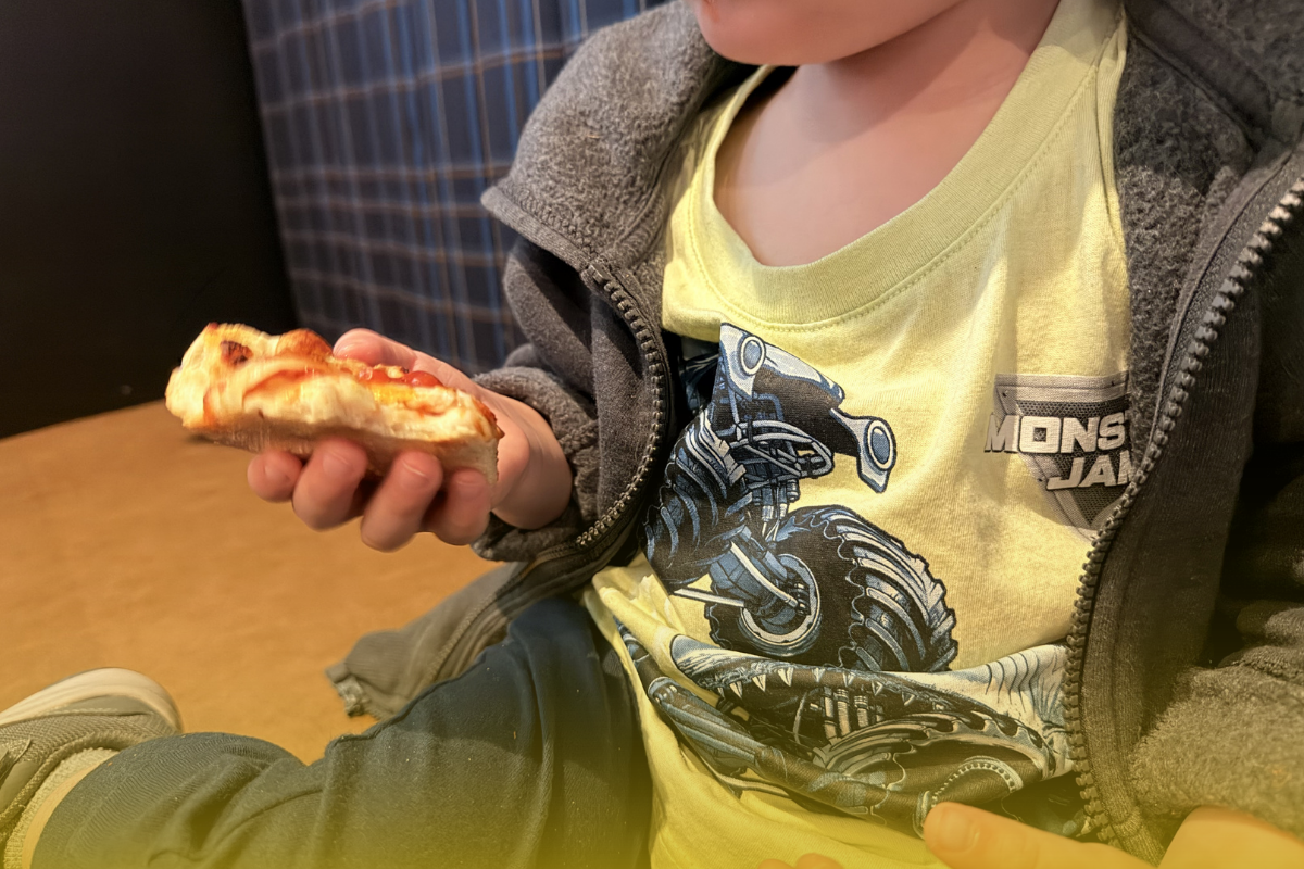 Toddler eating pizza