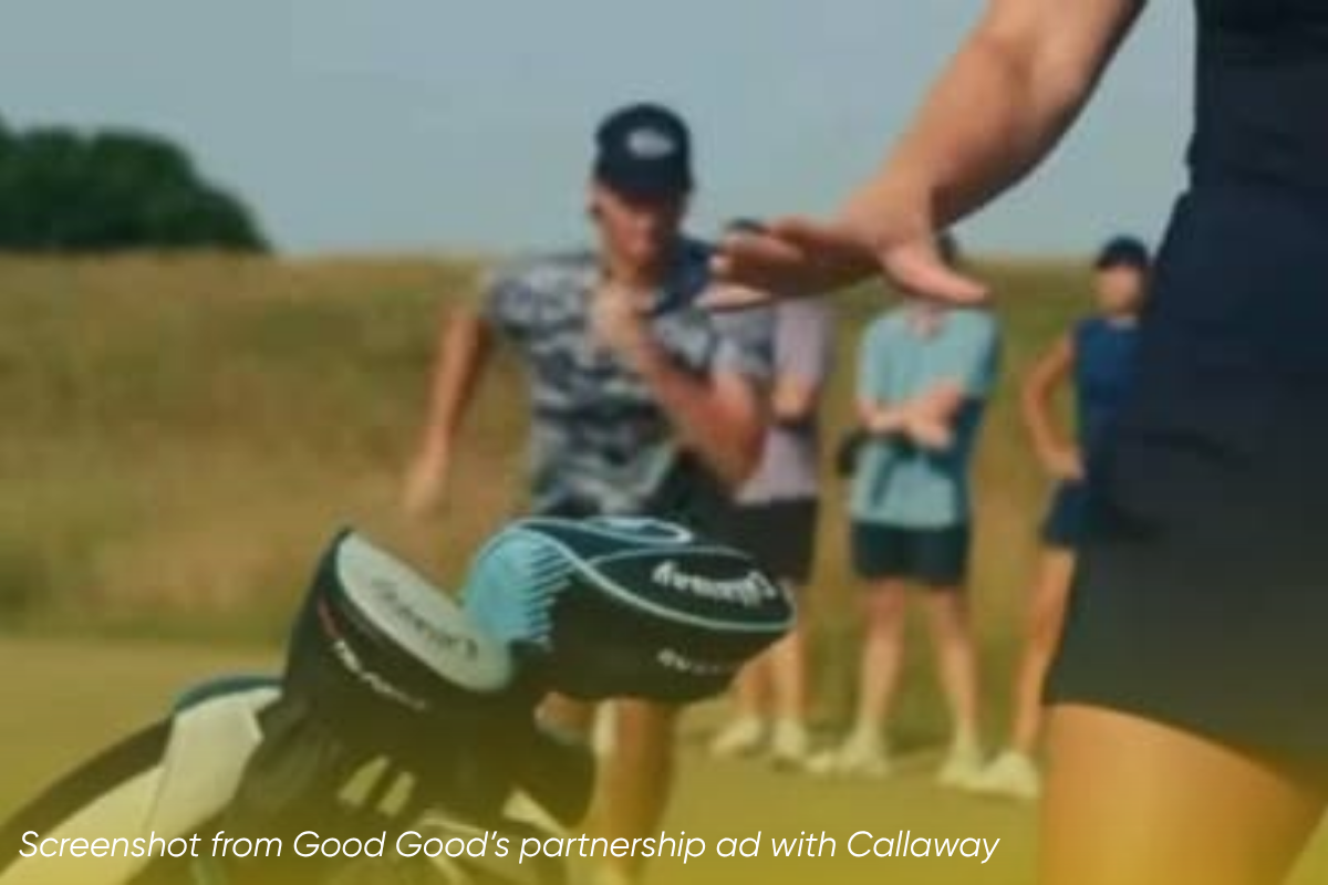 A screenshot from Good Good's ad. A man on a golf course runs toward a woman reaching her hand into a golf bag.