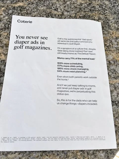 A photo of an ad from Coterie in Golf Digest. The ad is black text on a white page. The headline reads "You never see diaper adds in golf magazines."