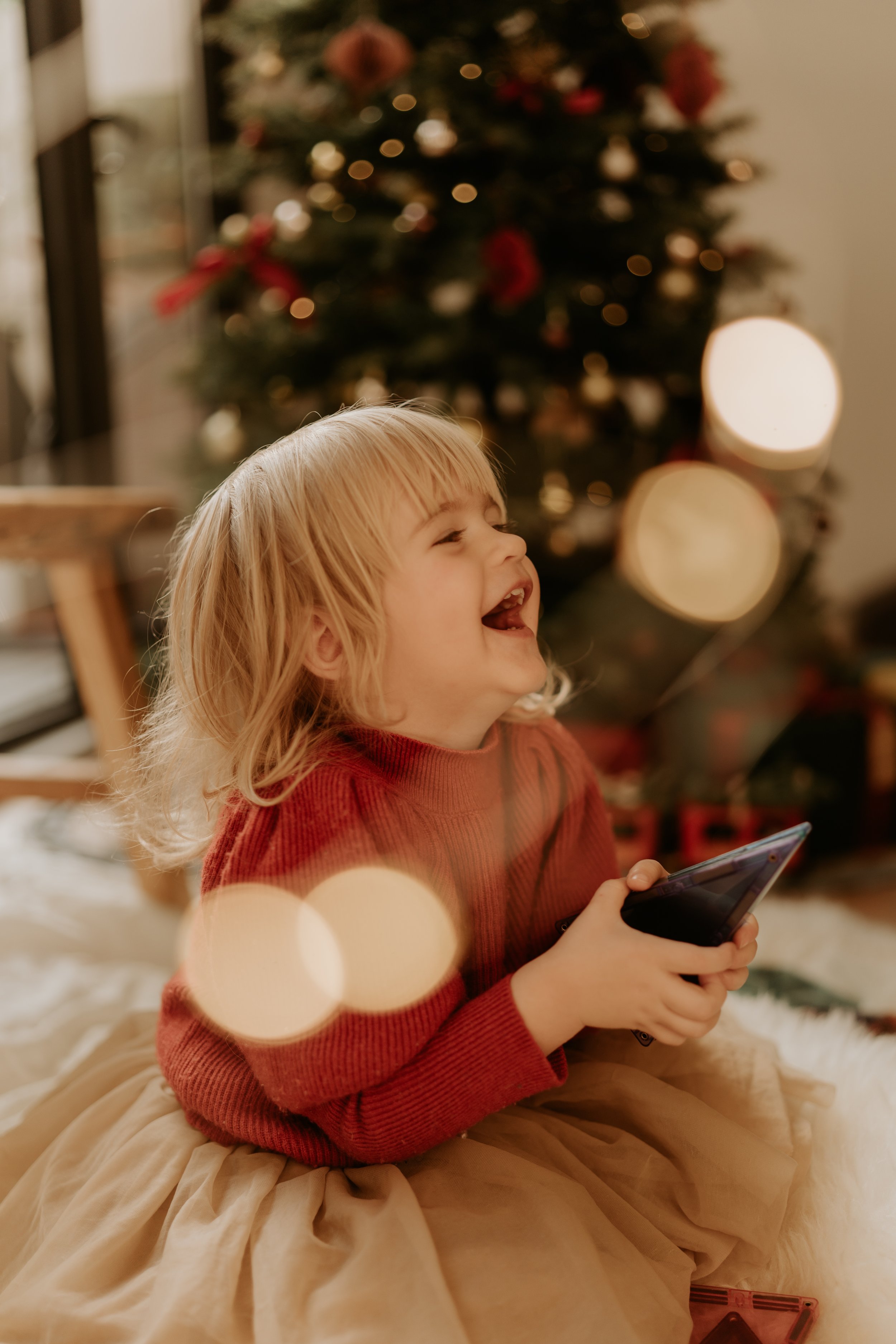 Christmas smile of a young girl with huge happiness and laugh over her face
