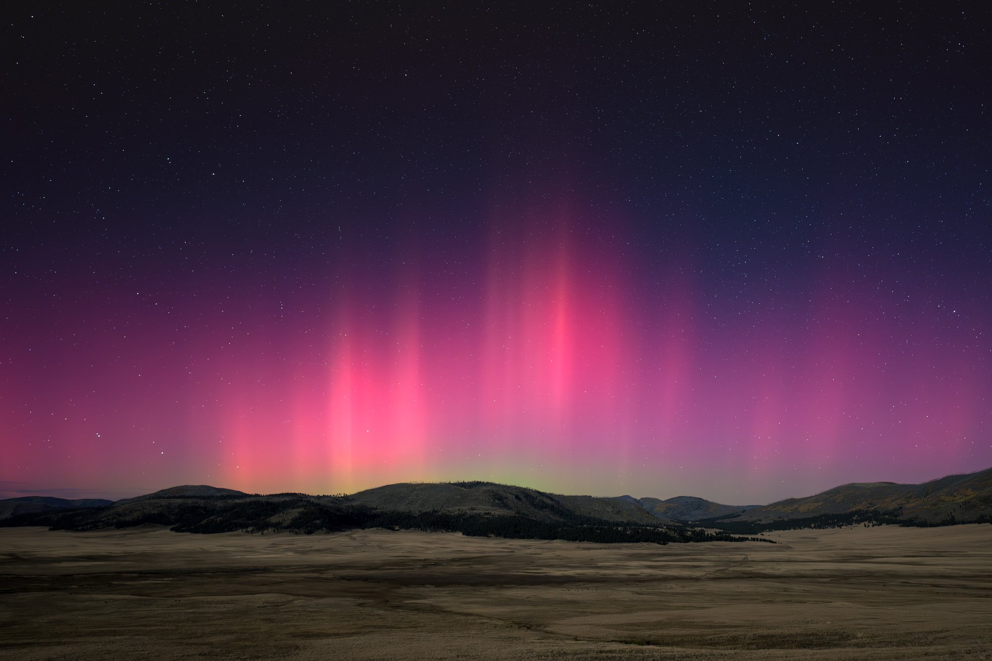 NIGHTSCAPES 2ND PLACE: AARON LEWIS - "Eruption." I captured this image of the aurora borealis at Valles Caldera last year following a strong solar flare event.  I have photographed the aurora in New Mexico multiple times in the past, but due to its u