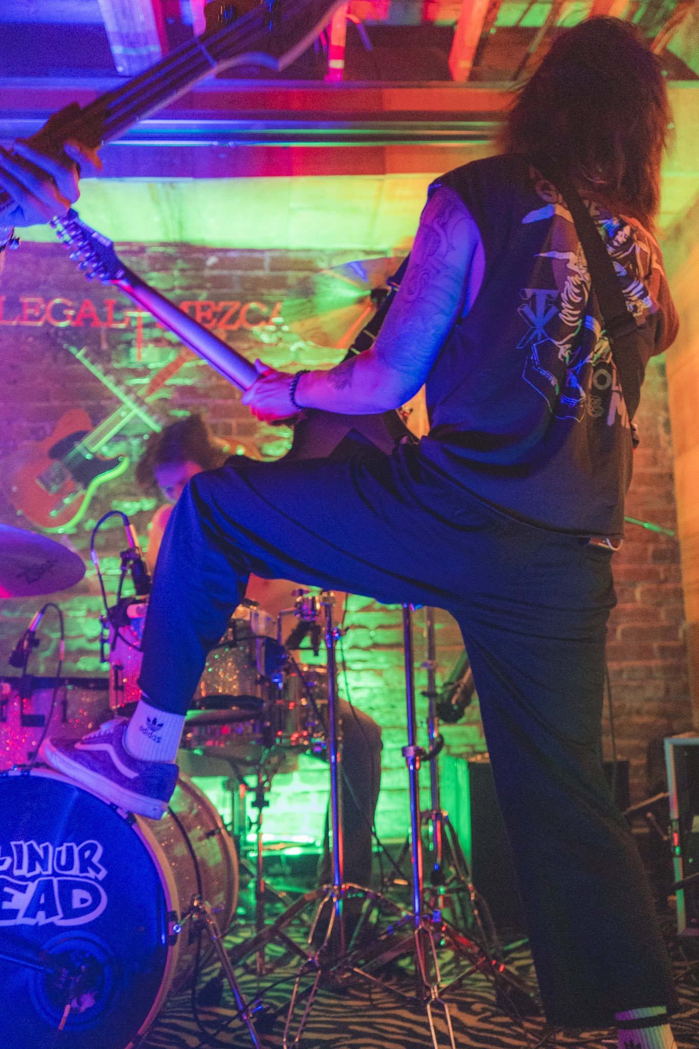 Live rock band performance with guitarist and drummer