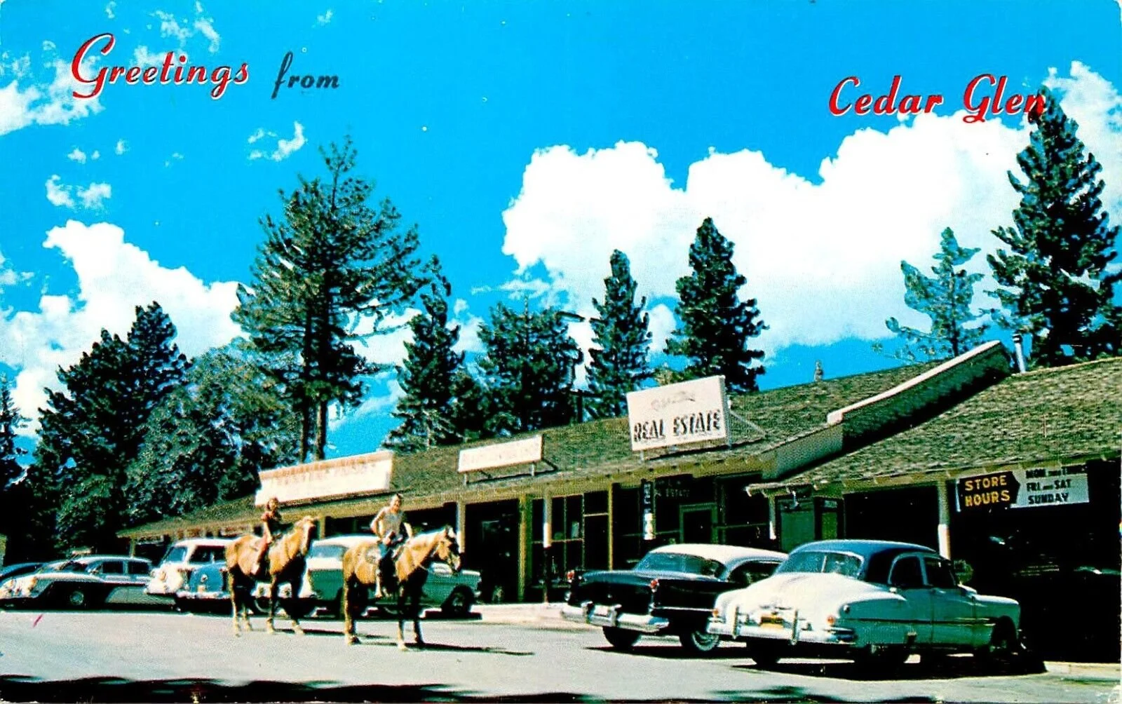 A vintage storefront with classic cars parked in front and people riding horses, under a bright blue sky with clouds. The sign reads 'Real Estate' and there's a welcoming message 'Greetings from Cedar Glen' at the top.
