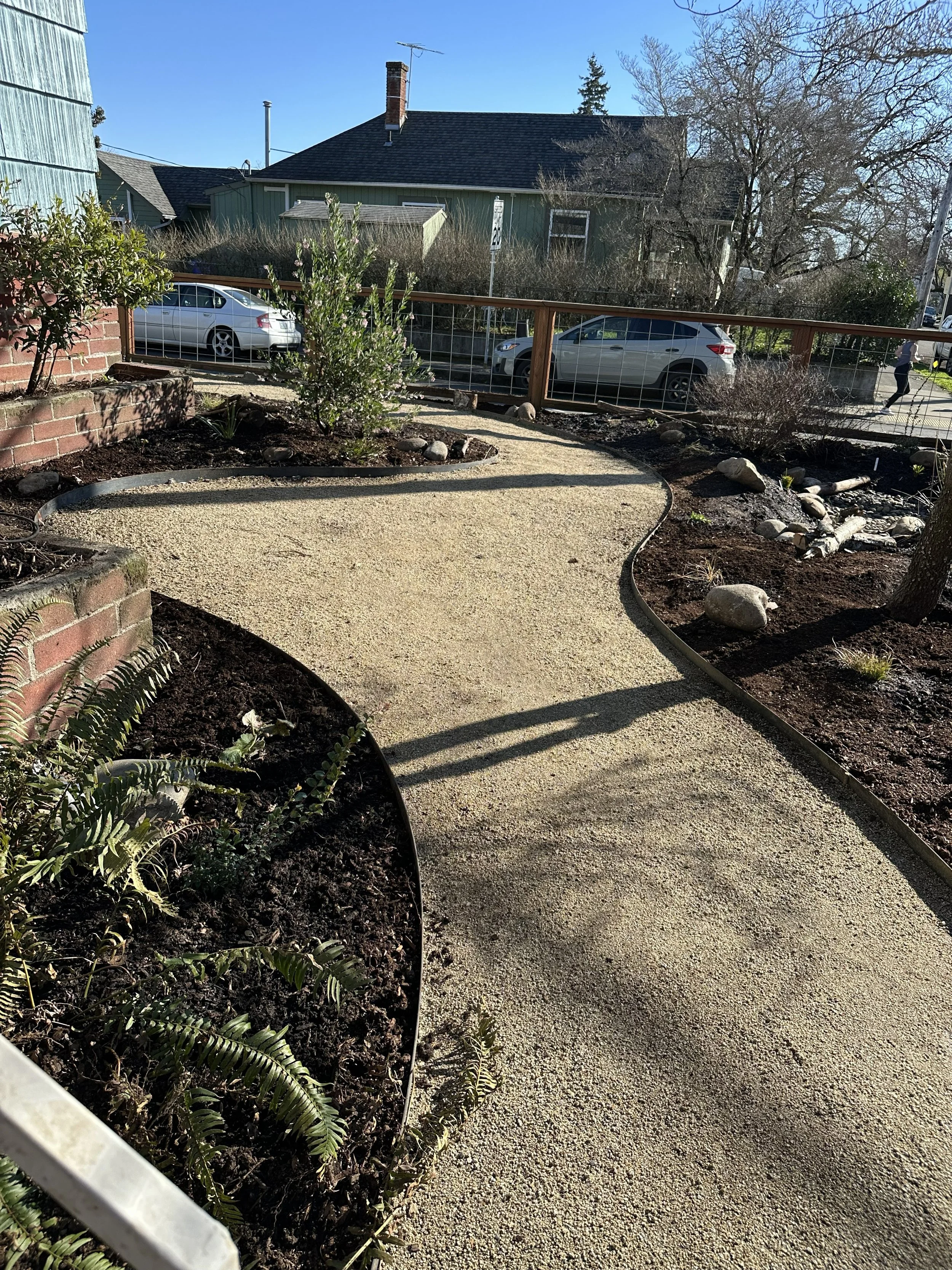Decomposed granite pathways with steel edging surrounded by native plantings in Southeast Portland