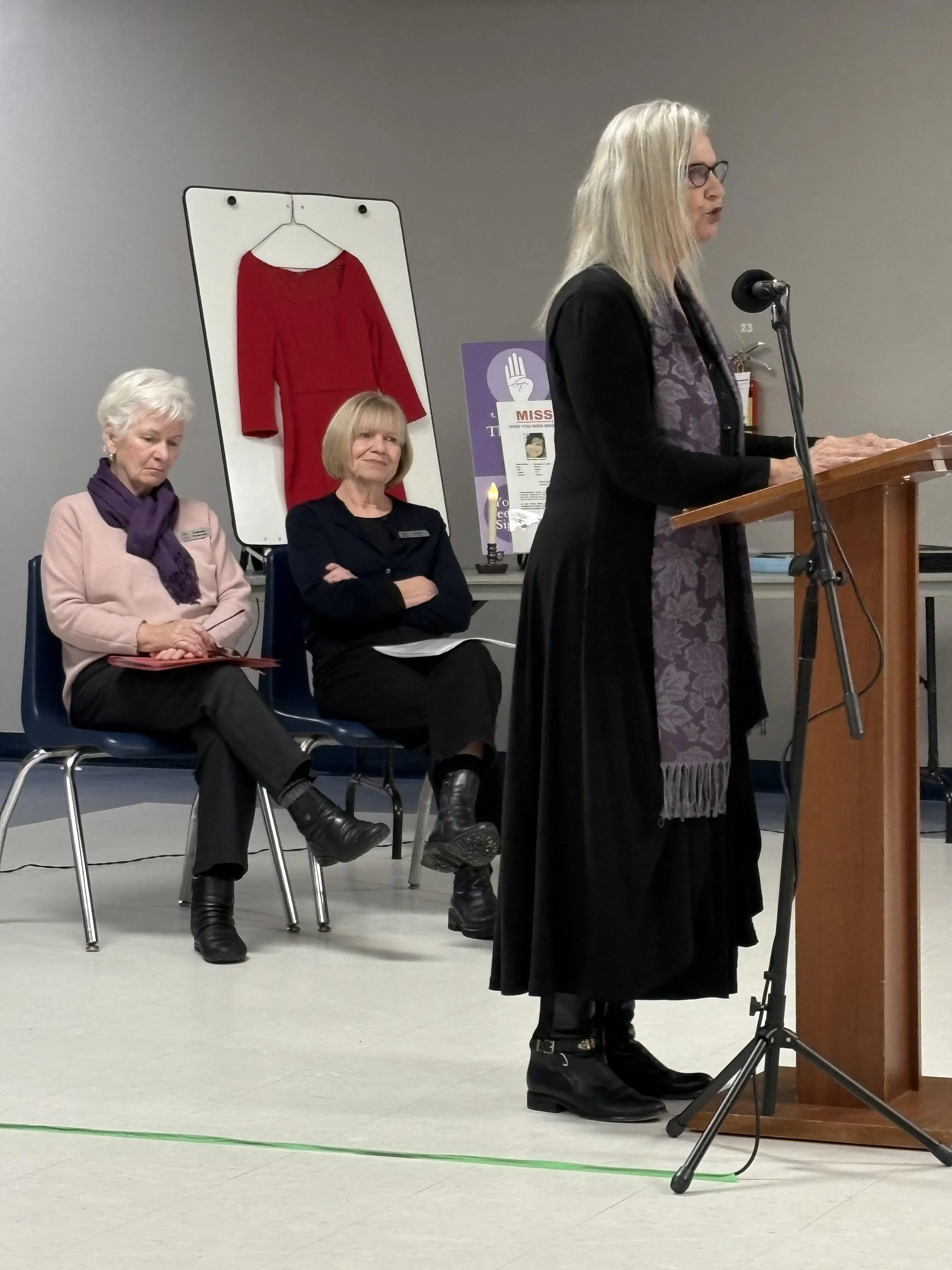 Gwen speaking at a podium