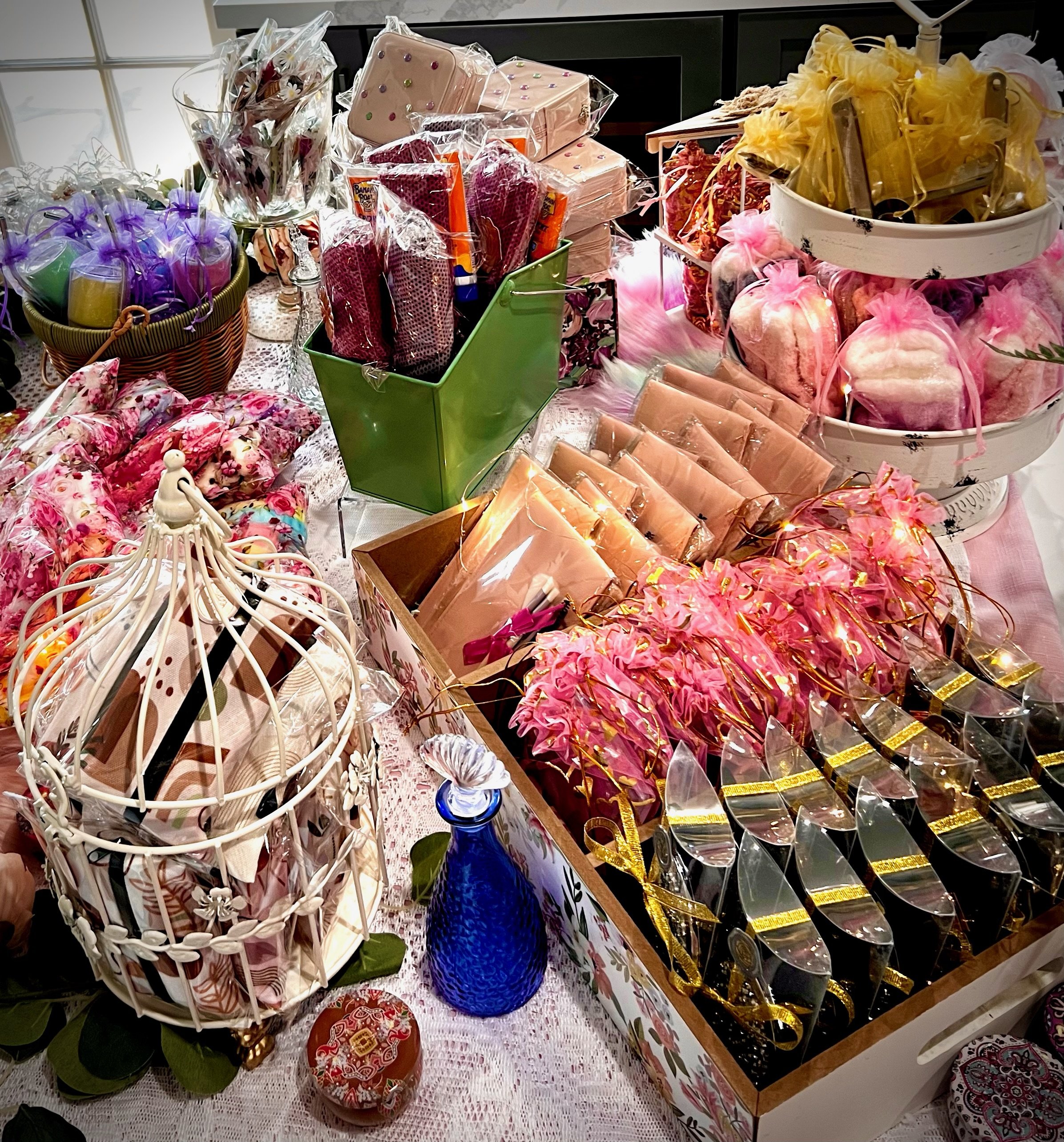 Various gift items displayed on a gift bar, including packaged bath products, decorative soaps, and colorful pouches.