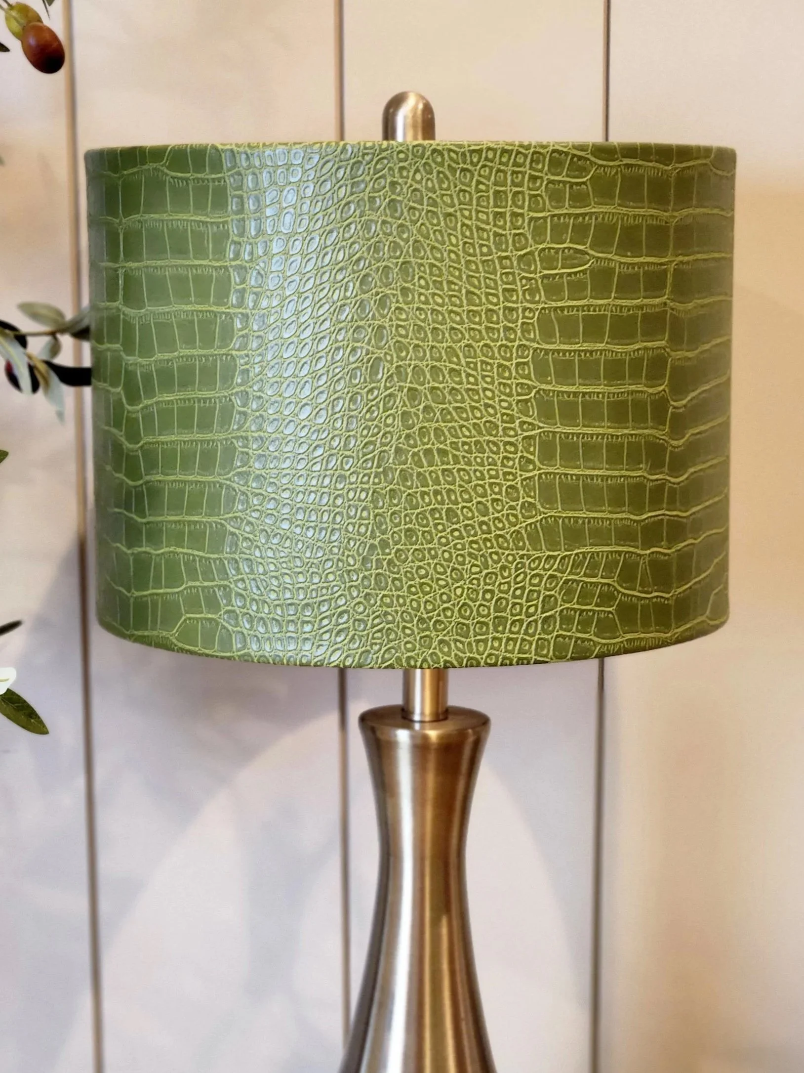 Close-up detail of green faux crocodile texture on handcrafted lampshade