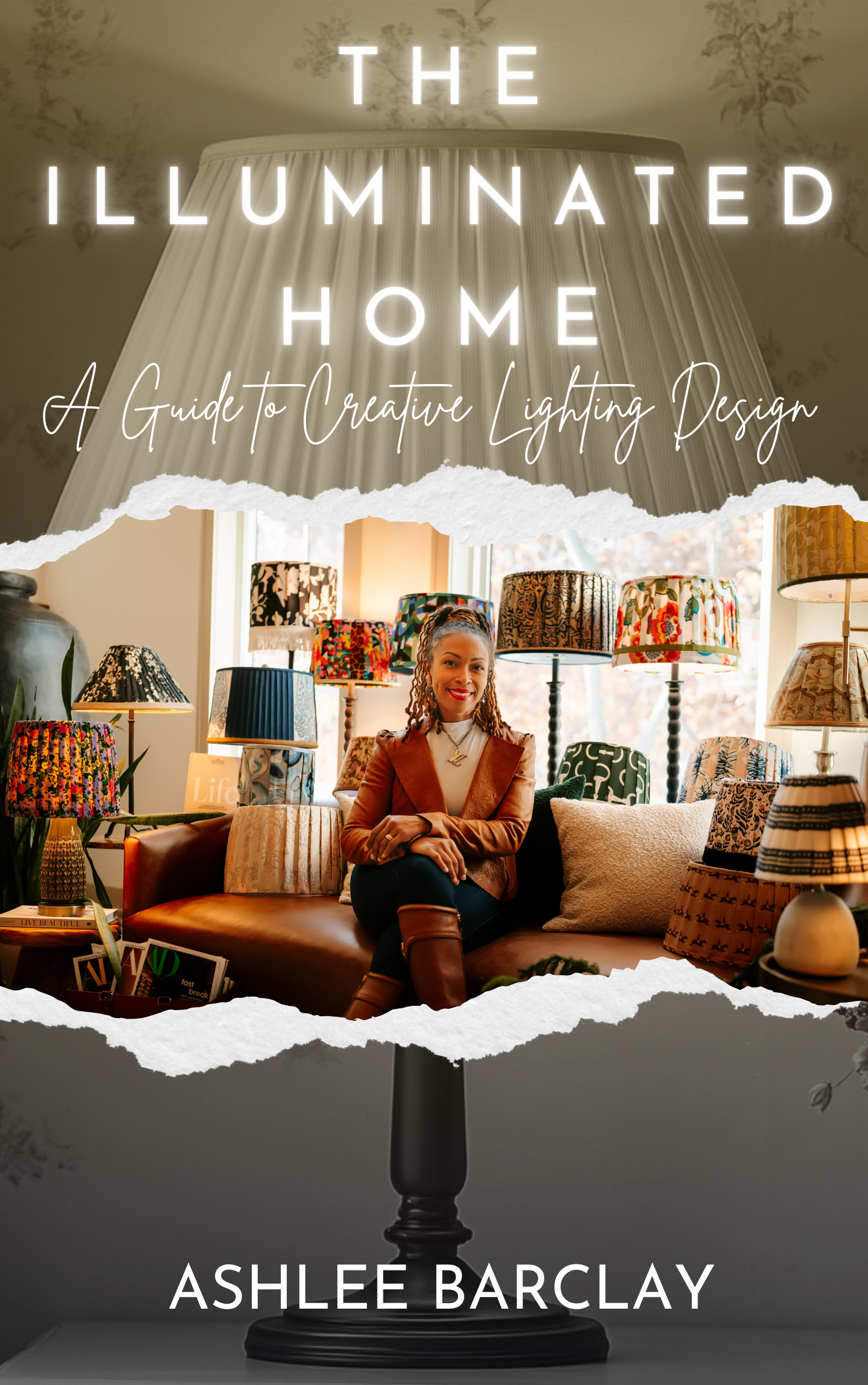 Book cover of "The Illuminated Home" by Ashlee Barclay featuring the author and an array of decorative lampshades.
