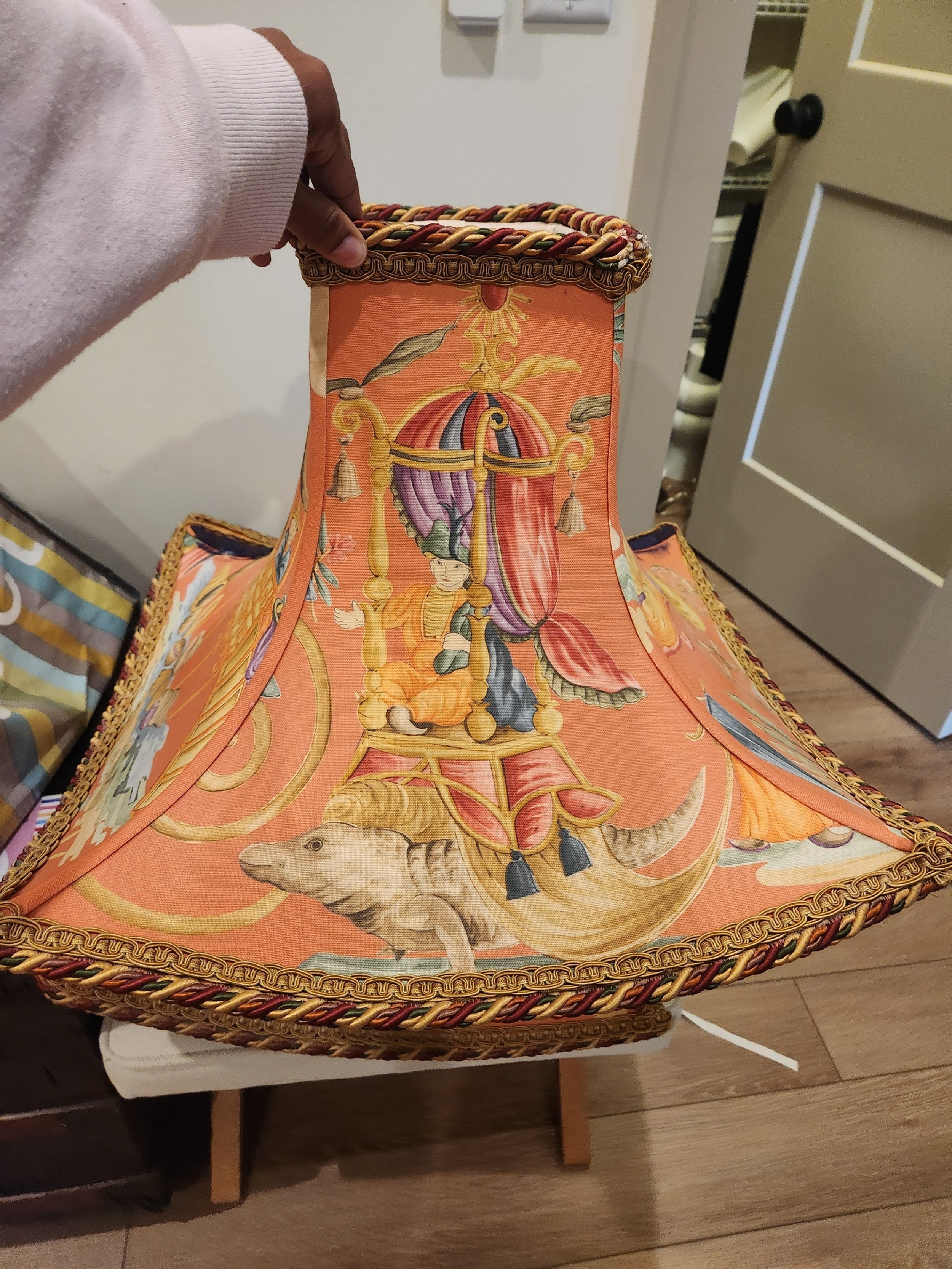 A colorful lamp with a circus themed pattern including an elephant, a performer in a chair, and decorative elements.