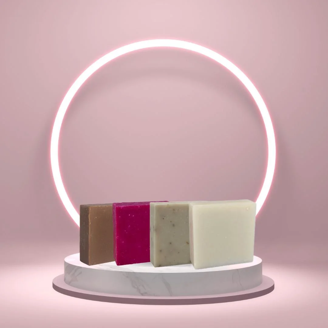 Build Your Heritage Set with four Heritage Line soap bars displayed on a white pedestal with a glowing pink circle background.