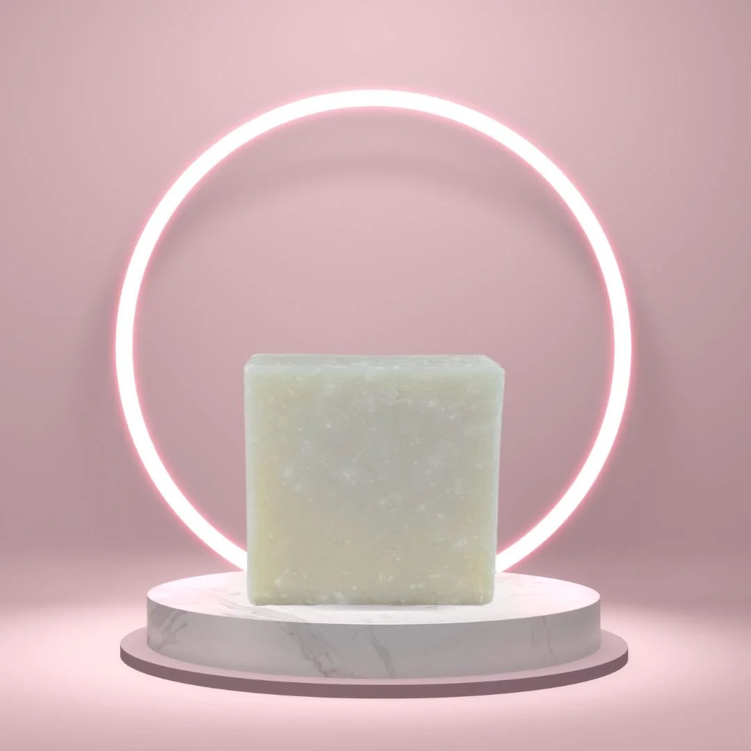 Big Sister handmade soap bar displayed on a marble pedestal with a glowing pink circular light.