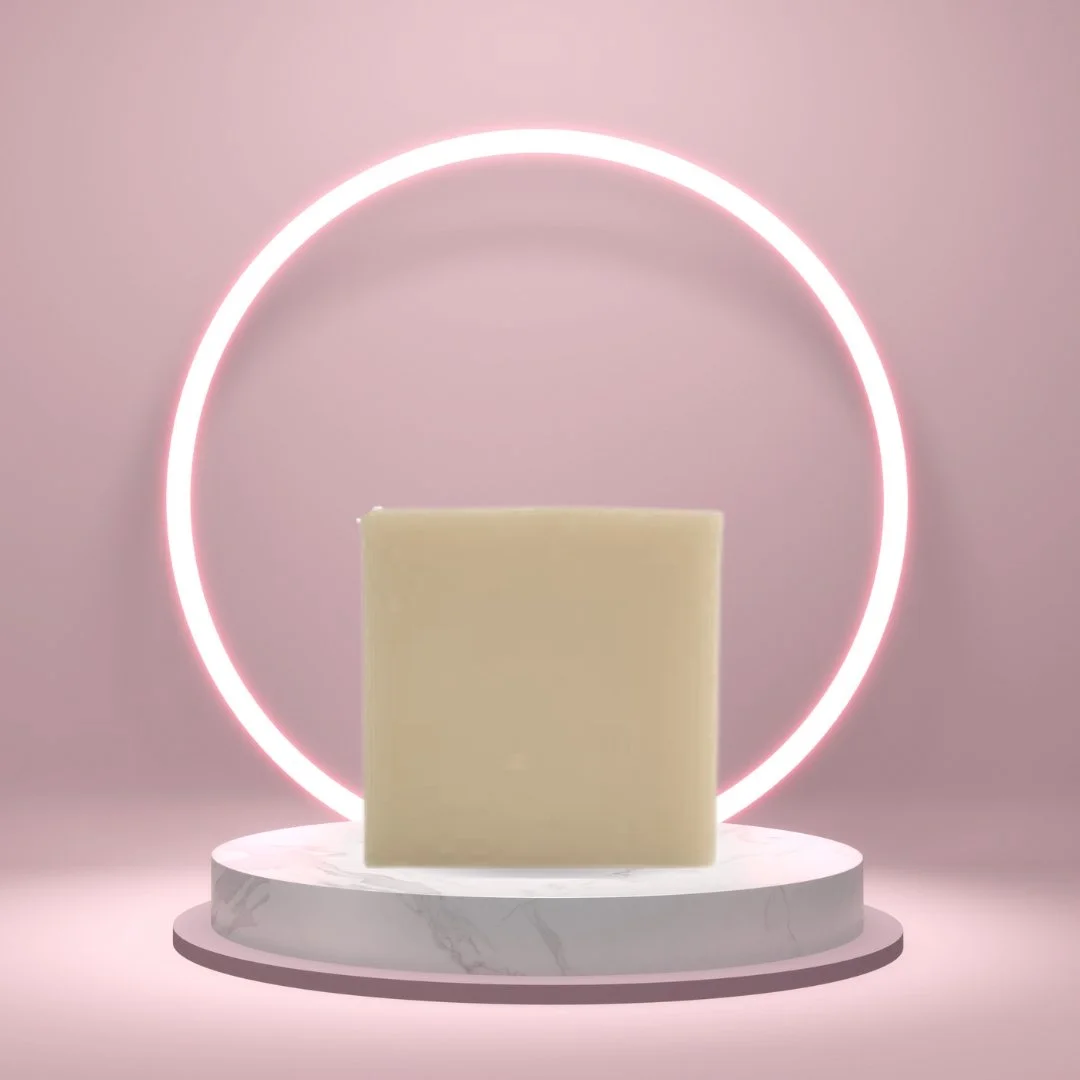 Bamboo Mud Soap Bar on a white pedestal with a glowing pink circle background.