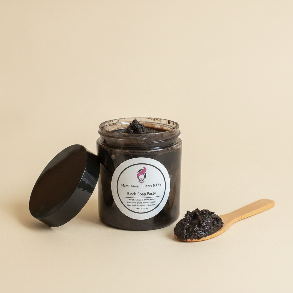 Open jar of Raw African Black Soap Paste beside a wooden scoop holding the thick soap paste.
