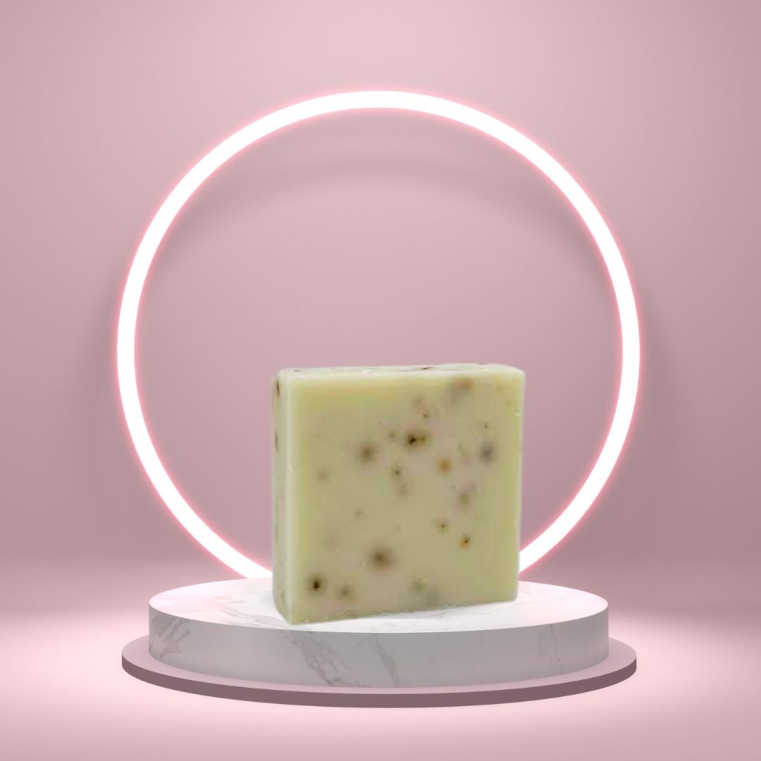 Tea Tree Mint Soap Bar on a white pedestal with a glowing pink circle background.
