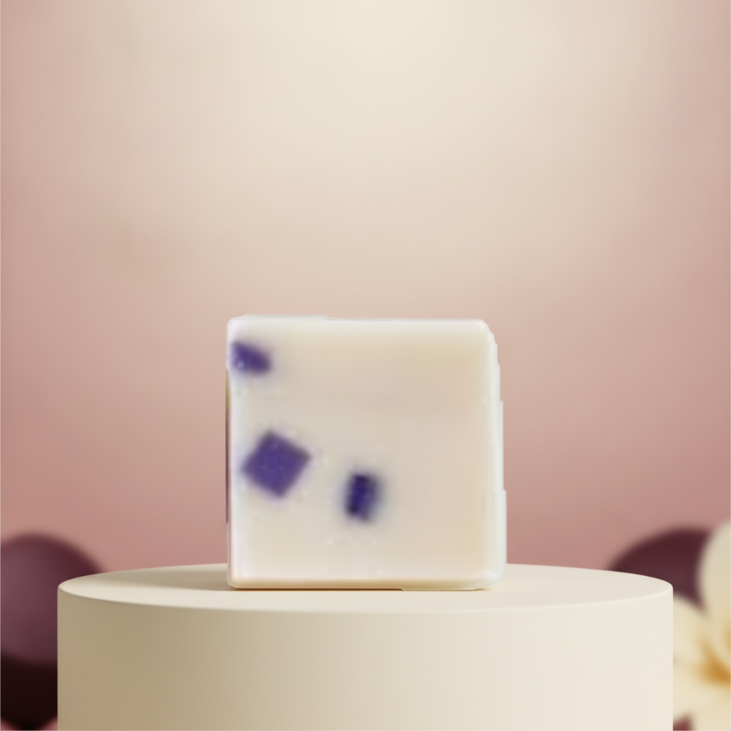 Black Raspberry Vanilla Soap Bar on a white pedestal with a soft pink background.