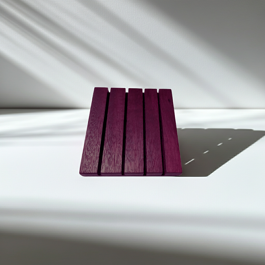 Square Edge Purple Heart wood soap dish lying flat on a white surface with soft diagonal shadows.