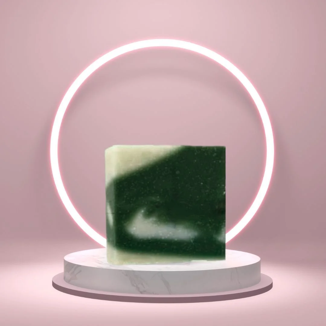 Cucumber Melon Soap Bar on a white pedestal with a glowing pink circle background.