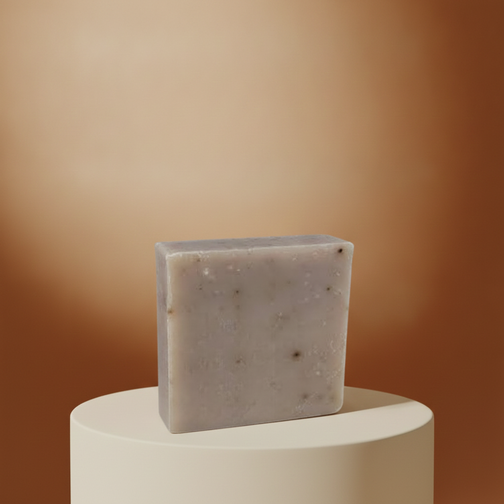 Oatmeal Spice Soap Bar on a cream pedestal with a warm golden background.