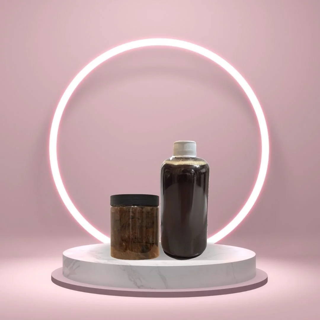Black Soap Two Ways liquid and paste duo on a white pedestal with a glowing pink circle against a blush background.