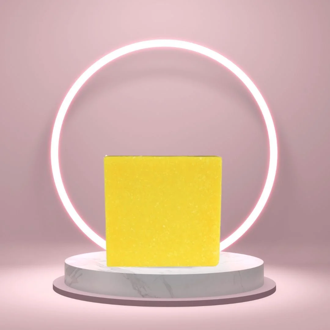Lemon Zest Soap Bar on a white pedestal with a glowing pink circle background.