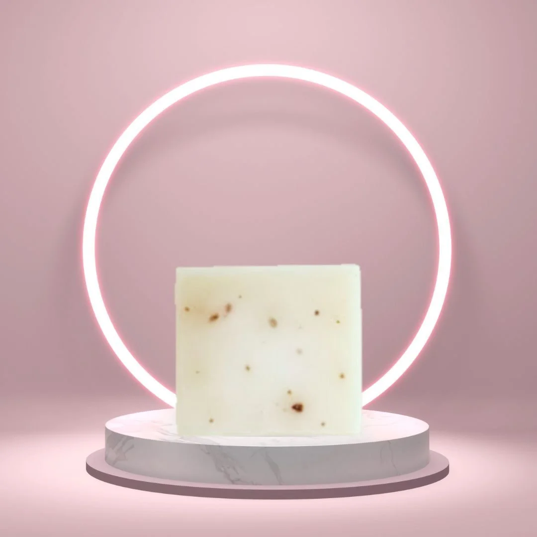 African Violet Soap Bar on a white pedestal with a glowing pink circle background.
