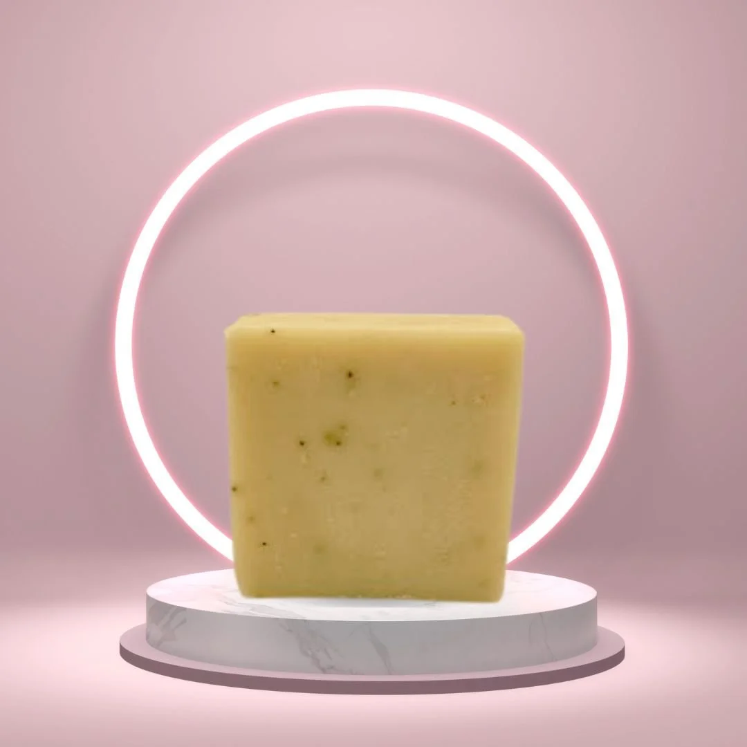 Cinnamon Latte Soap Bar on a white pedestal with a glowing pink circle background.