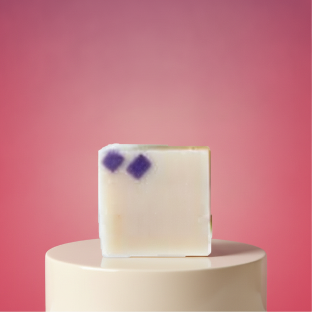 Black Raspberry Vanilla Soap Bar on a white pedestal with a bold pink background.