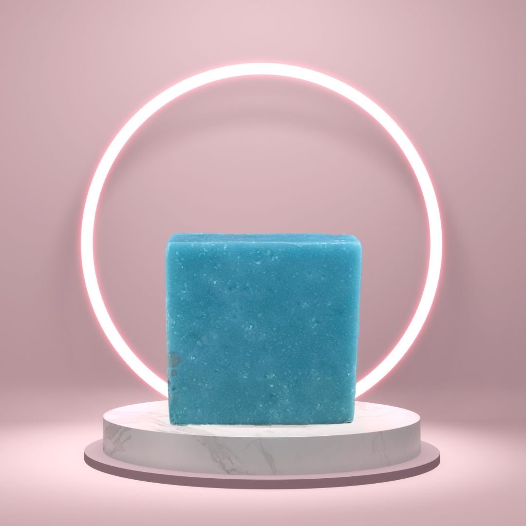 Cool Spring Scrub Soap Bar on a white pedestal with a glowing pink circle background.