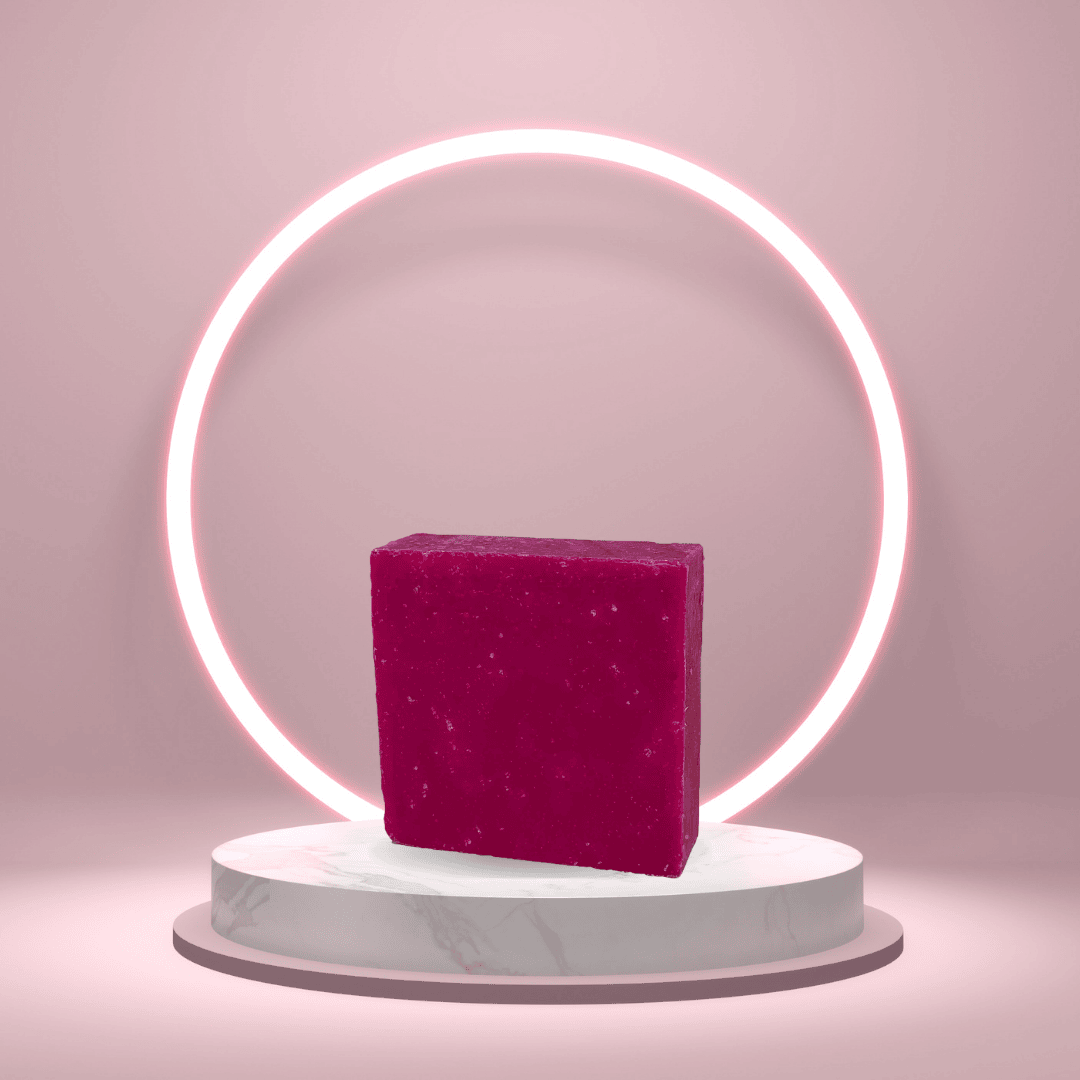 Sun-Kissed Empress handmade soap bar on a pedestal with a glowing pink ring backdrop