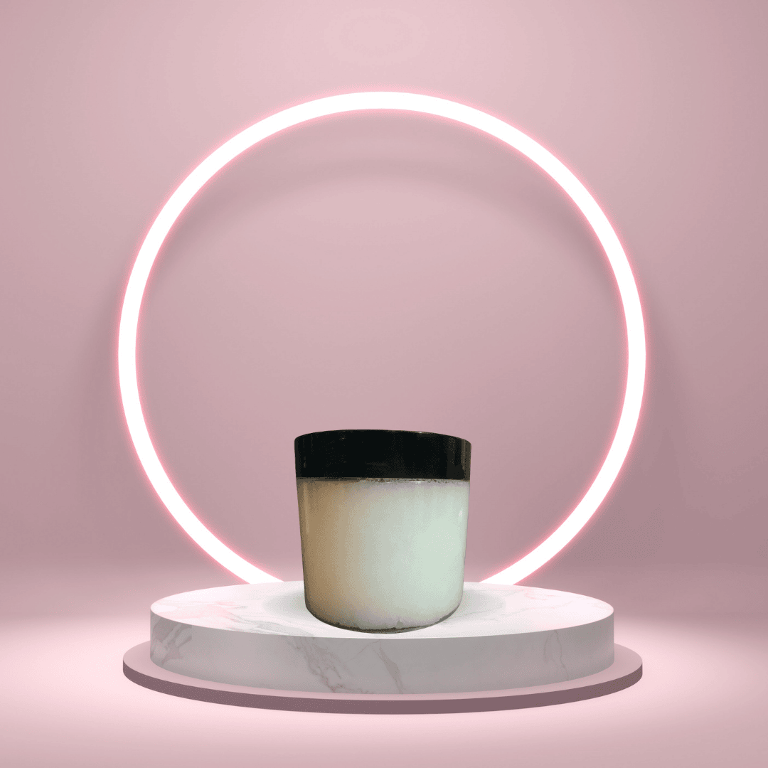 A polished hero image of The White Line by Mama Aswan Unscented Raw Sugar Scrub 16oz styled on a pink pedestal with a wooden spoon, highlighting its clean, simple, fragrance-free appeal.