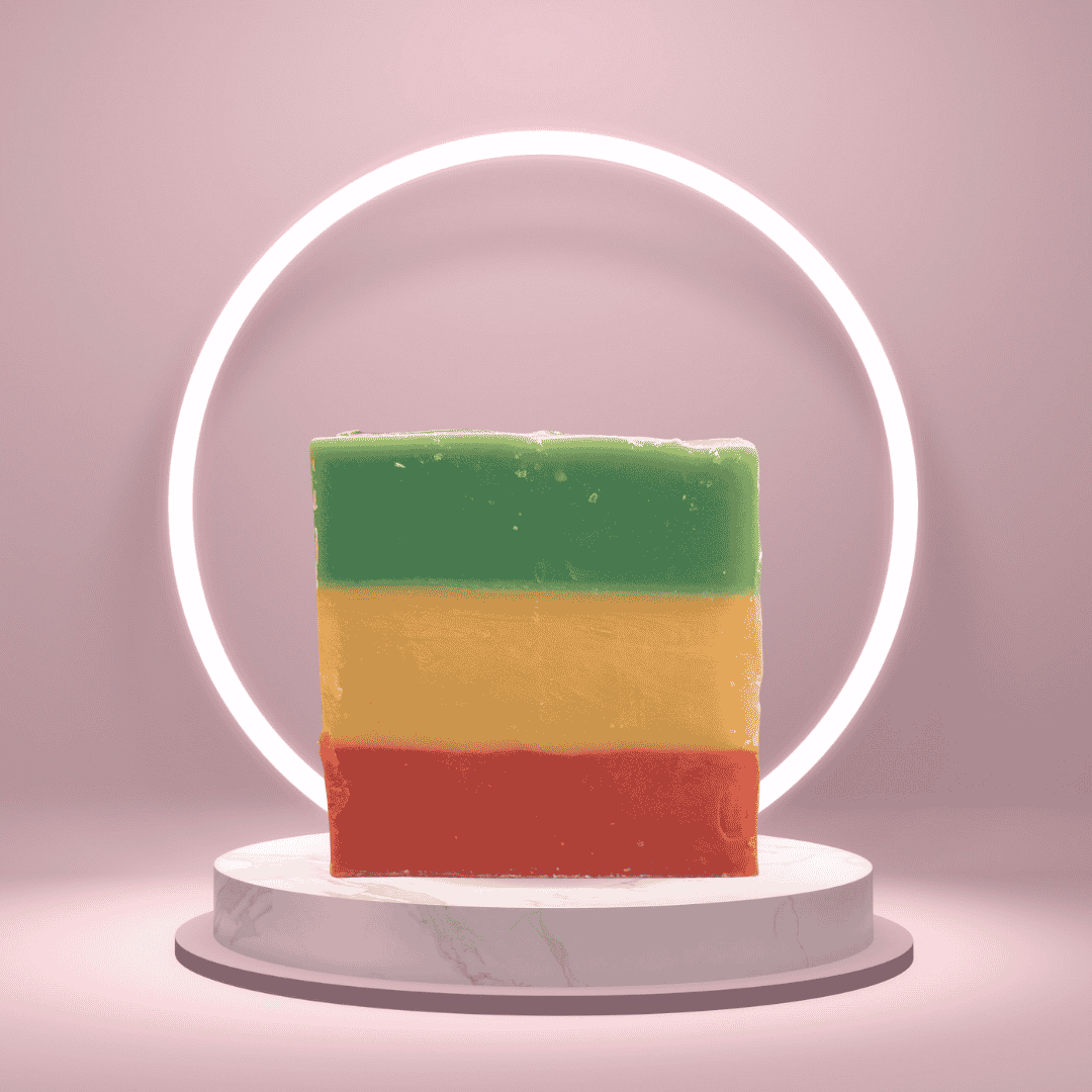 Rasta Roots Heritage Soap with green, gold, and red horizontal layers displayed on a pink pedestal