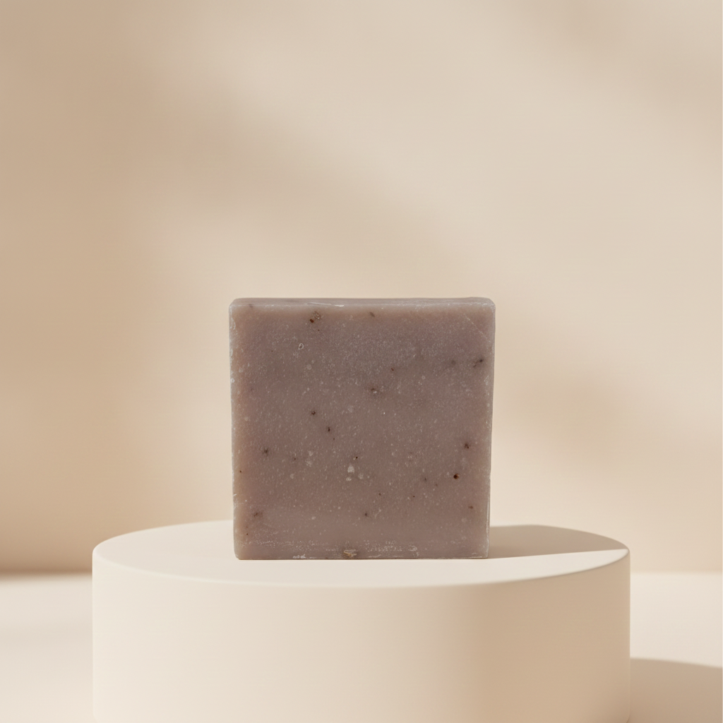 Oatmeal Goat’s Milk Soap displayed on a cream pedestal against a soft beige background.