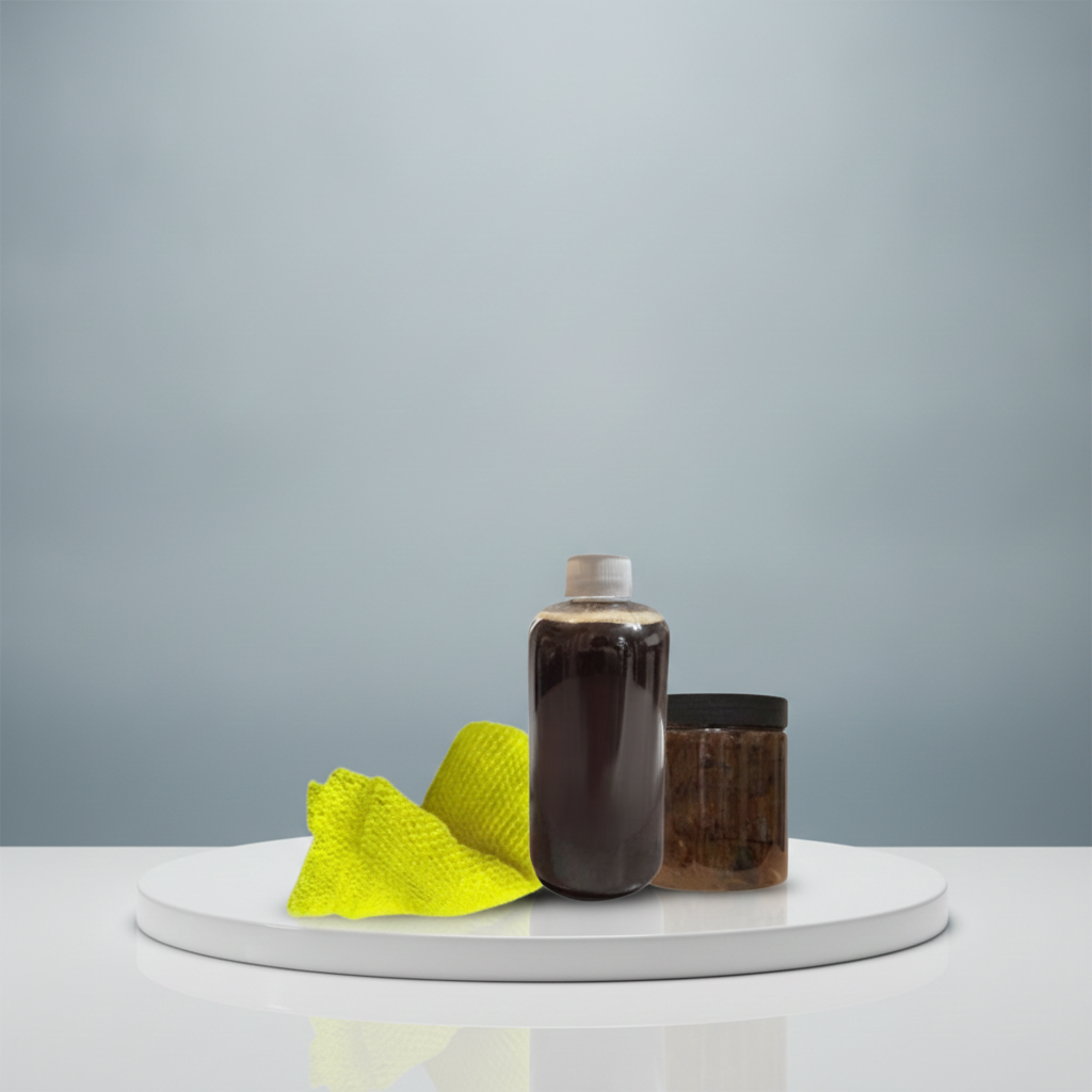 Black Soap Two Ways set with liquid African black soap, black soap paste, and yellow Sapo Sponge on a white pedestal.