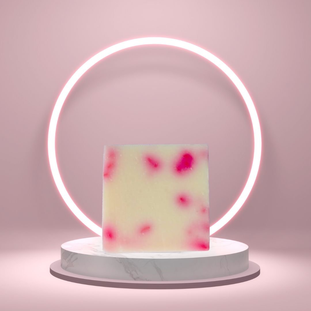 Asian Tea Blossom Soap Bar on a white pedestal with a glowing pink circle background.