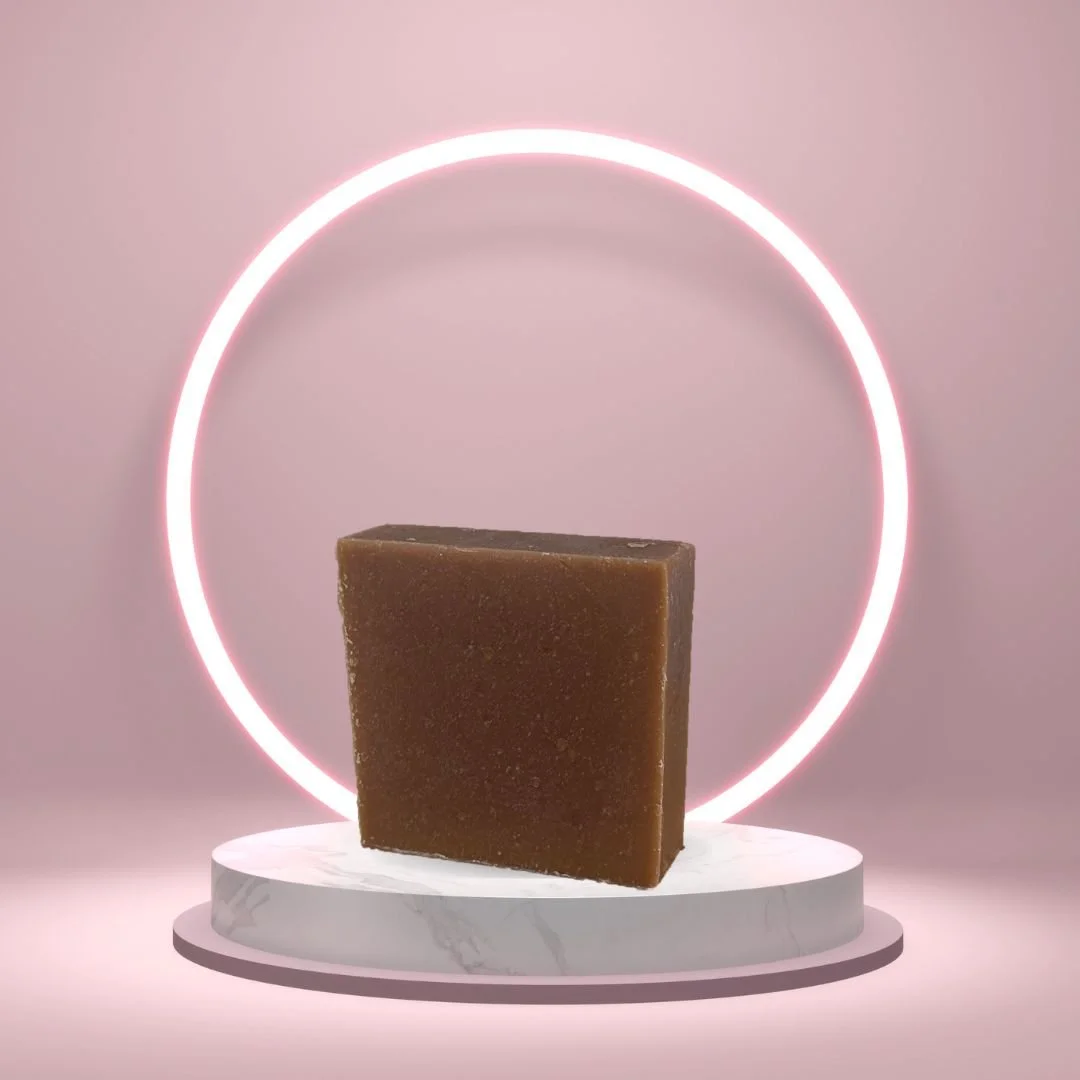Nag Champa Mud Soap Bar on a white pedestal with a glowing pink circle background.