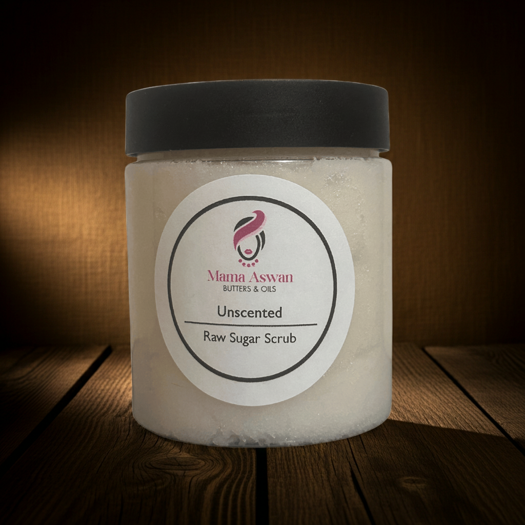 Unscented Raw Sugar Scrub by Mama Aswan displayed on rustic wooden boards with dramatic warm lighting.